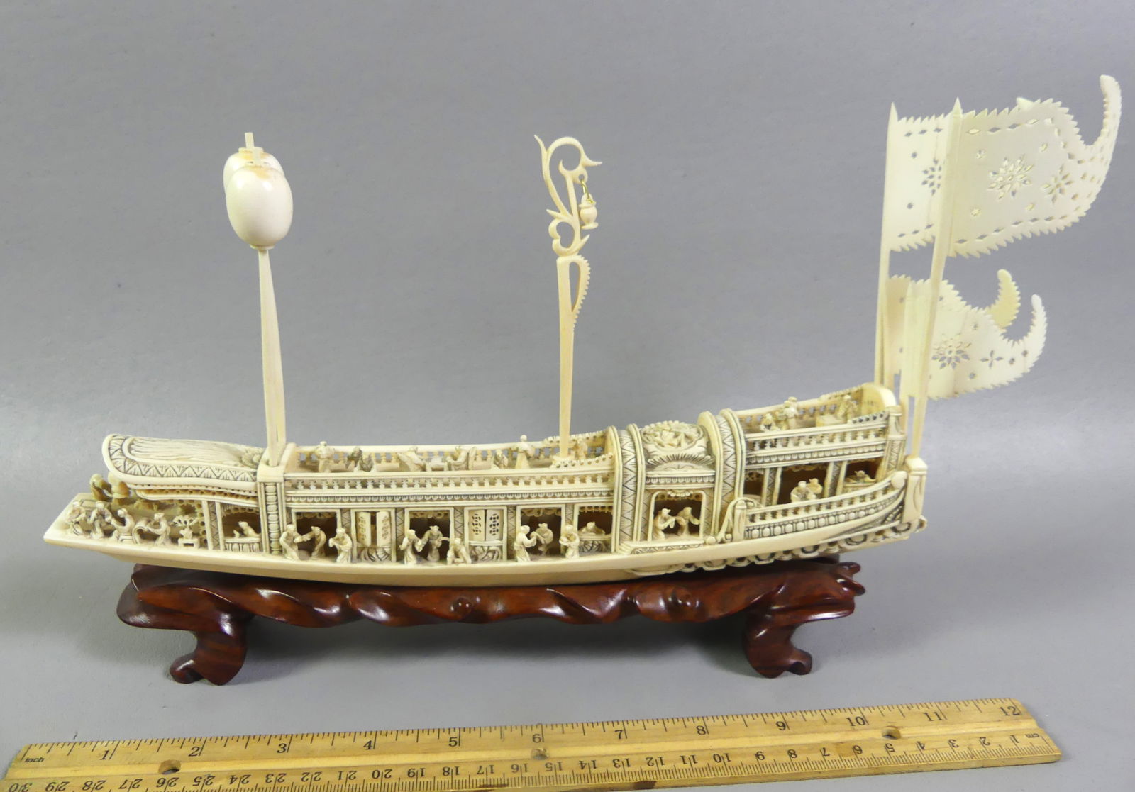 CHINESE CARVED YACHT WITH FIGURES: Fine antique Chinese carved bone royal yacht with 50+ tiny figures on board. It has removable flags and decorative poles. 11 x 8 x 2 in wide. VG condition. NOTE: We can ship this item in-house.