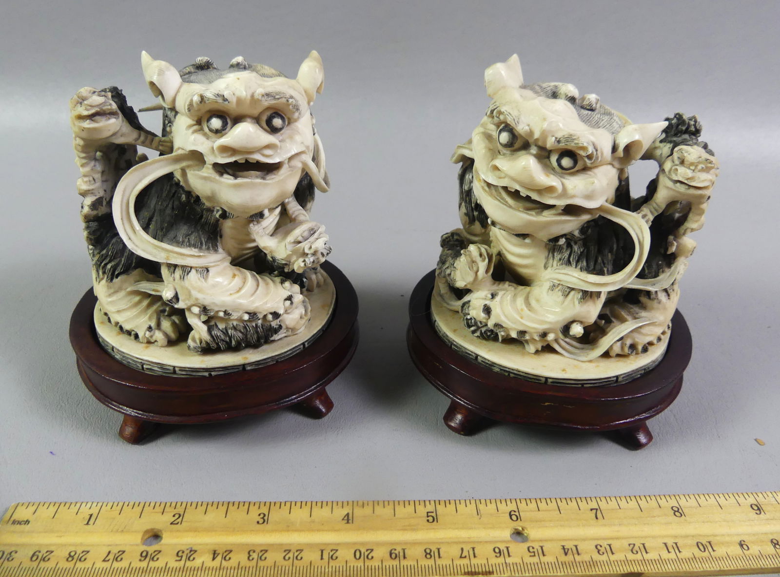 PAIR ASIAN CARVED FOO LION FIGURES: Pair of antique Asian carved bone figures of foo lions with 4 baby foo lions playfully surrounding each one. Both signed on underside, attributed Chinese late 19th century. Size: 4 x 3.2 x 3 inches,