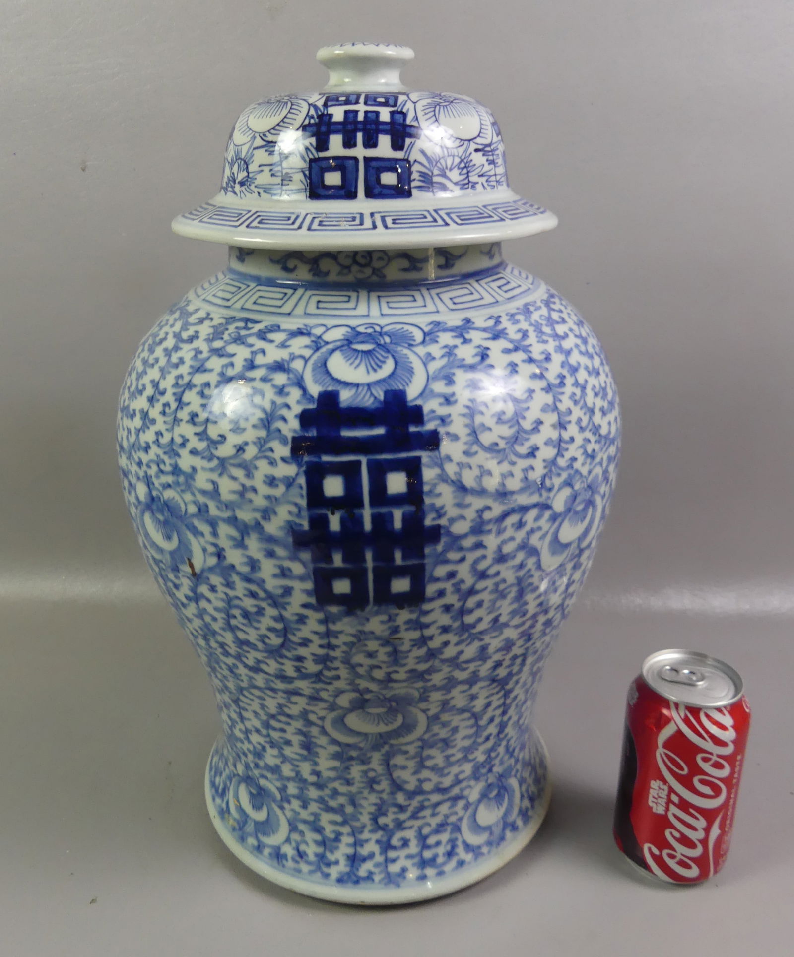 ANTIQUE CHINESE URN - FLORAL & SYMBOLS: Antique Chinese blue and white covered urn with floral designs and symbols, 17.5 in high, 9 in diameter of base. Has 4 character mark signature, very good condition. NOTE: We can ship this item
