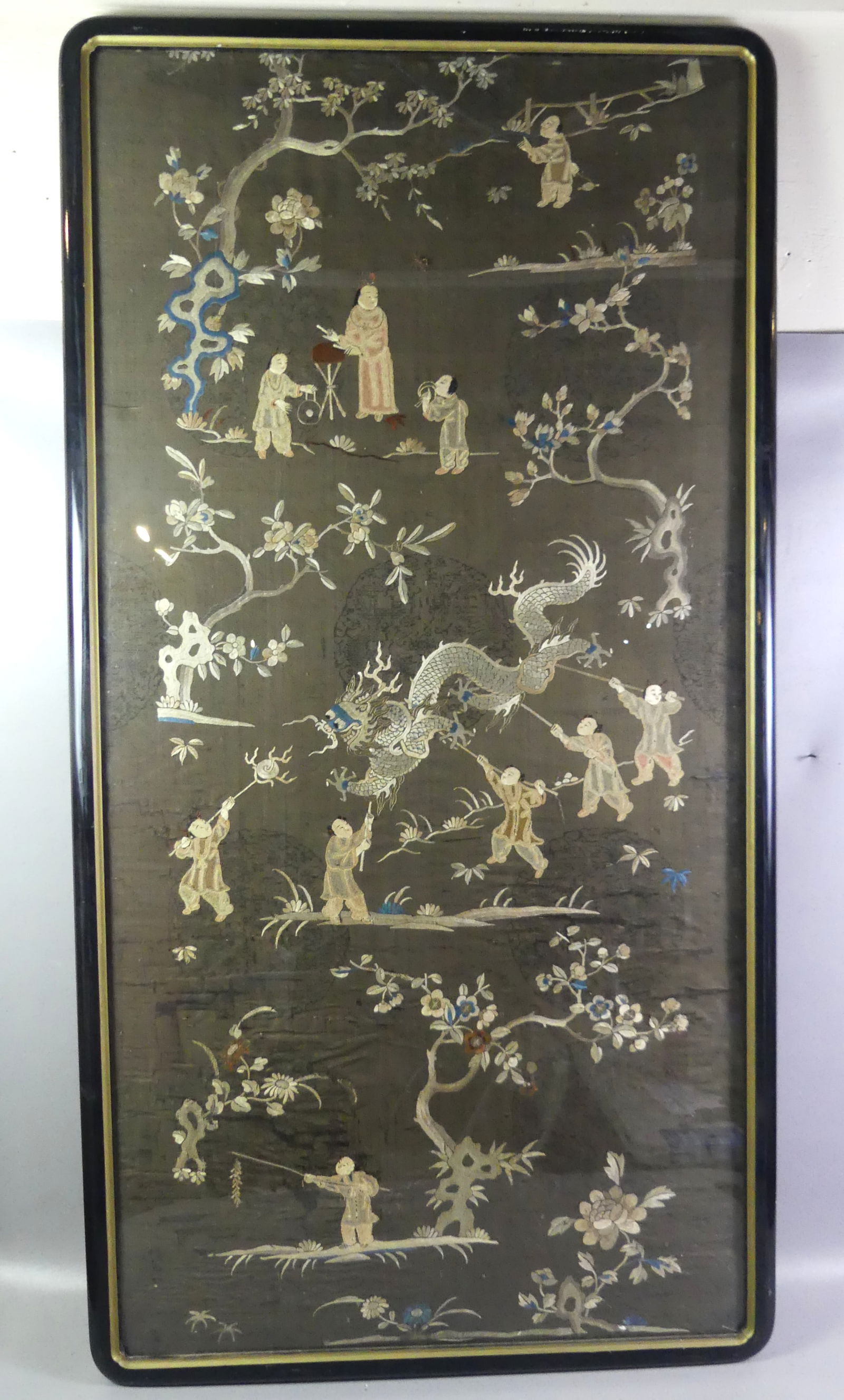 LARGE CHINESE FRAMED EMBROIDERY: Large antique Chinese embroidered silk panel with various genre scenes, dragon, flowering trees. 60 x 30 in, framed 63 x 33 in. Good condition. NOTE: We can ship this item in-house.