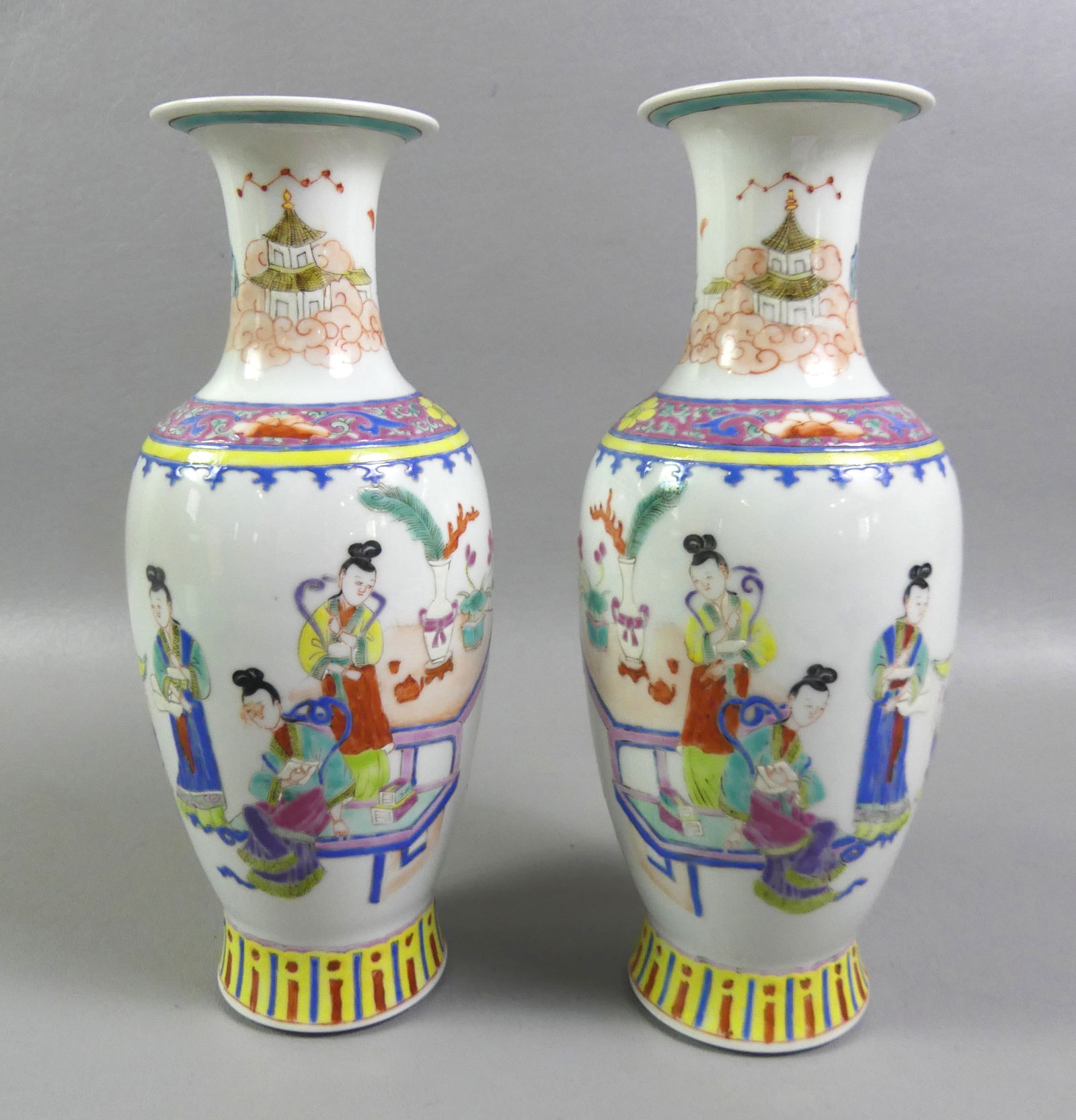 PAIR CHINESE FAMILLE ROSE VASES: Pair of old Chinese porcelain famille rose vases with genre scenes. Both have stamp on underside. 10 in tall, VG condition. NOTE: We can ship this item in-house.