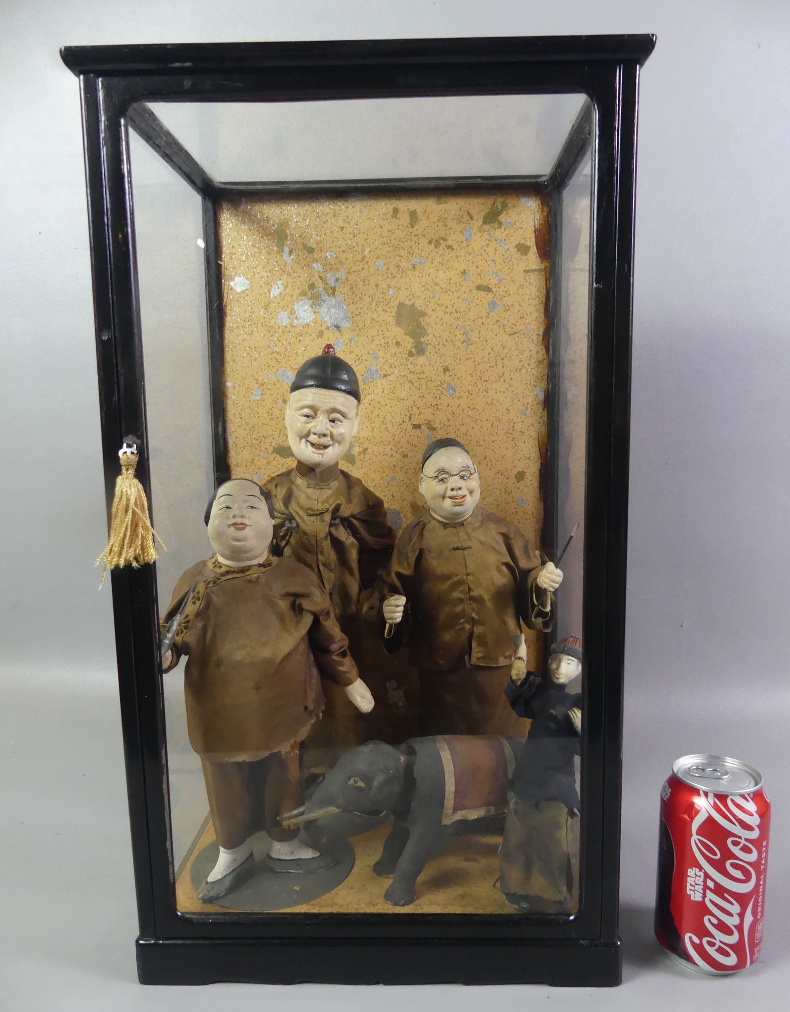 4 OLD CHINESE DOLLS IN CASE: Lot of 4 antique Chinese composition dolls to 14 in tall and a paper machier nodding-head elephant. All in glass and wood display case 21 x 12 x 9 inches. Sold as is with some scattered imperfections