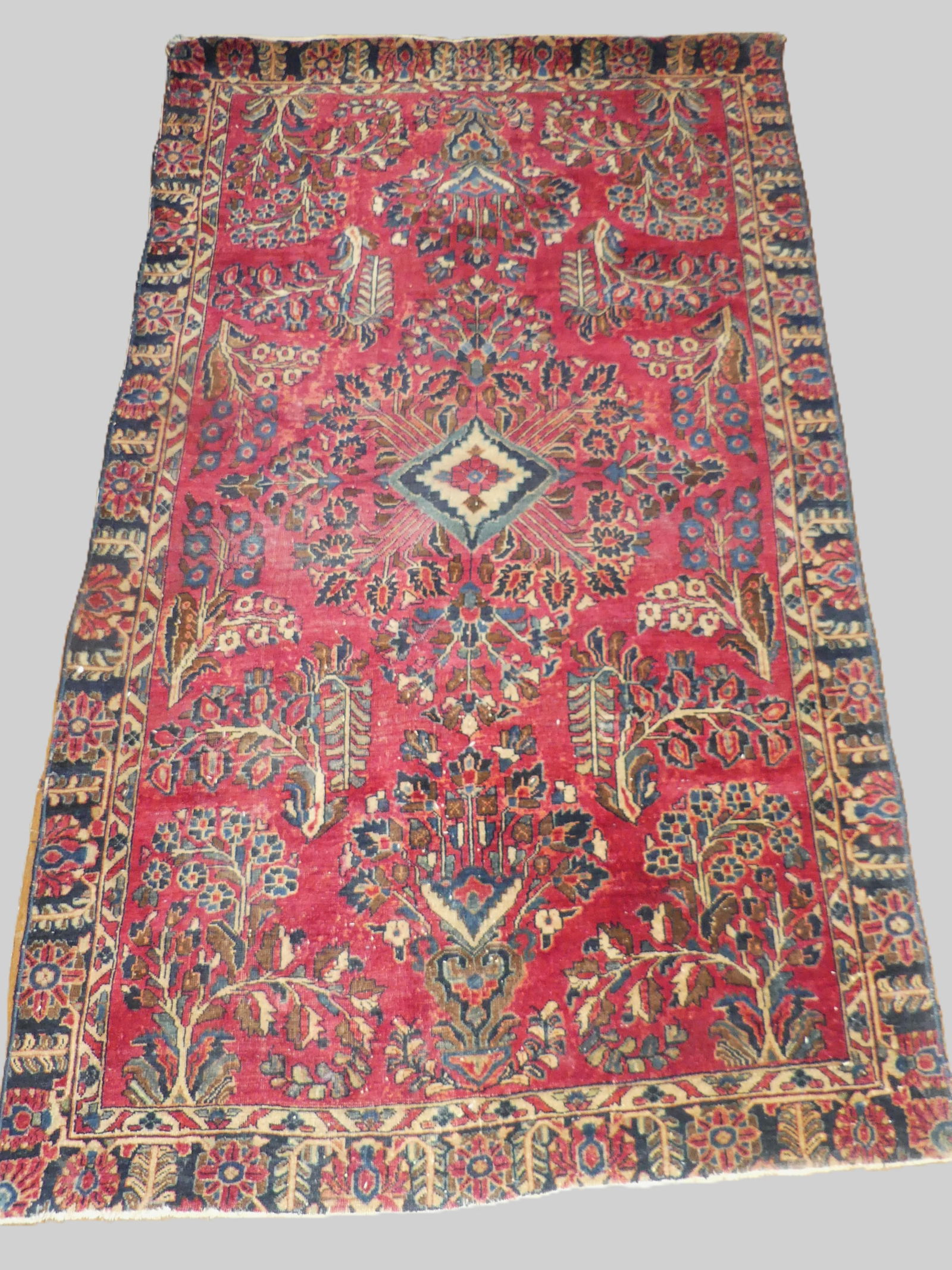 ANTIQUE SAROUK SCATTER RUG: Antique painted Sarouk scatter rug, edges have been trimmed, 3 ft 10 in x 6 ft 10 in. Sold as found. NOTE: We can ship this item in-house.
