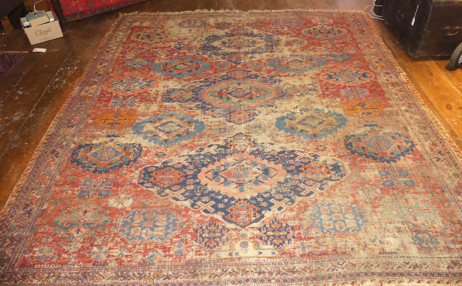 19TH C. TRIBAL RUG - ROOM SIZE: Fine antique tribal rug in reds and blue with scattered medallion design. Has much wear and few scattered holes. Sold as is. 9 ft 4 x 10 ft 3 in. NOTE: We can ship this item in-house.