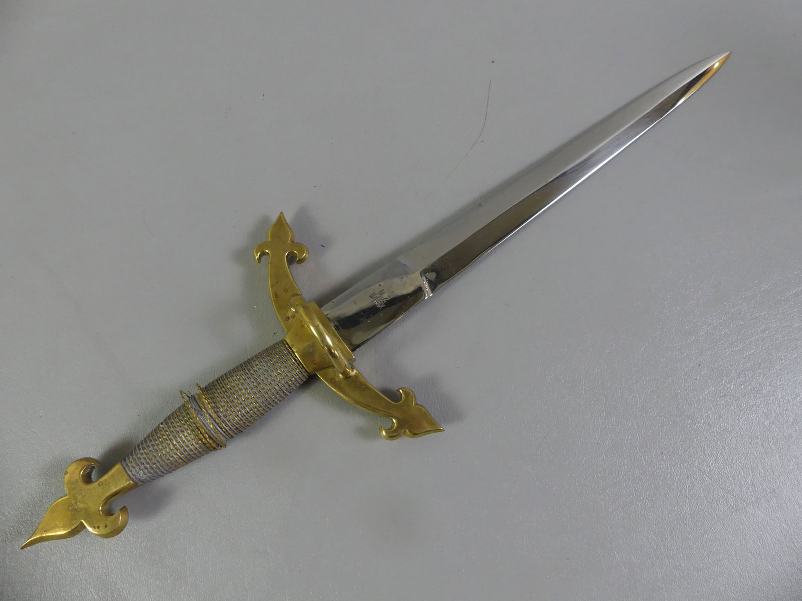 TOLEDO OF SPAIN DAGGER - ZAMORANO: Vintage reproduction brass-handled dagger signed MZ Toledo. Wire-wrapped handle (some loose strands). 19 in long, blade is 11.75 in. NOTE: Mariano Zamorano is one of the last authentic sword makers
