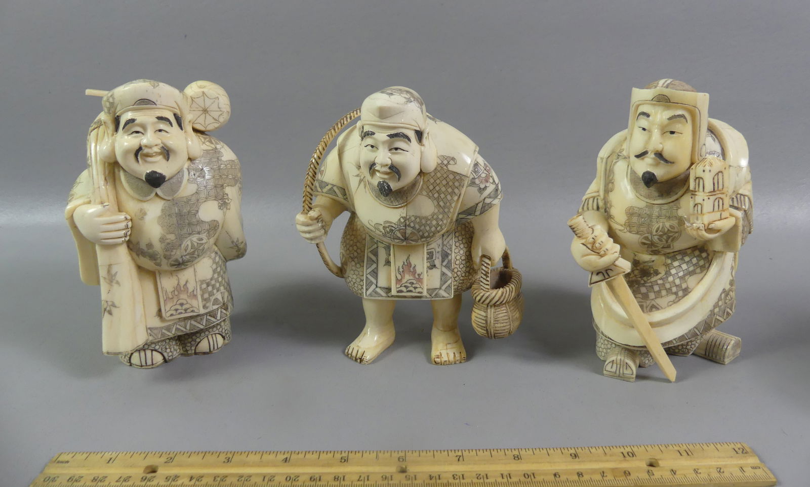 3 JAPANESE CARVED FIGURES: Set of 3 antique Japanese carved bone chunky figures, 6.5 x 4.5 x 4 inches: Fisherman; warrior with sword, and man with hammer and sack. Unsigned, companion pieces to lot above. NOTE: We can ship