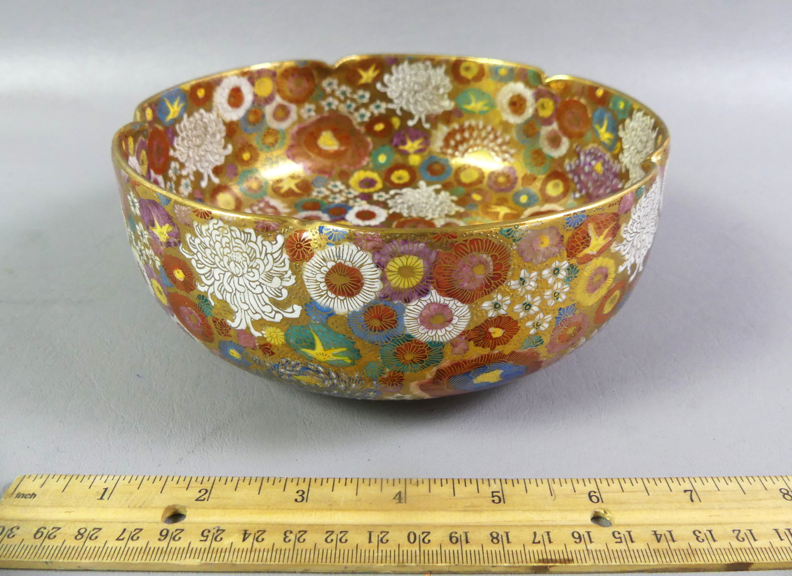 JAPANESE MEIJI BOWL - MILLEFIORE DESIGN: Fine Japanese Meiji period art pottery bowl with elaborate Millefiore floral design, enamelwork and gilding. Signed on underside with orb mark and characters. 7.25 x 3 in high. VG condition. NOTE: We