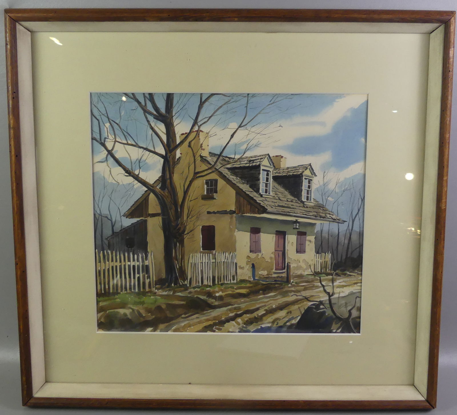 JOHN LYNCH - PAINTING OF HOUSE: Circa 1940 watercolor painting of a cape home with dormers signed John Lynch. 18 x 20 in, framed 29 x 31 in. (John Lynch 20th c. NY artist and illustrator). NOTE: We can ship this item in-house.