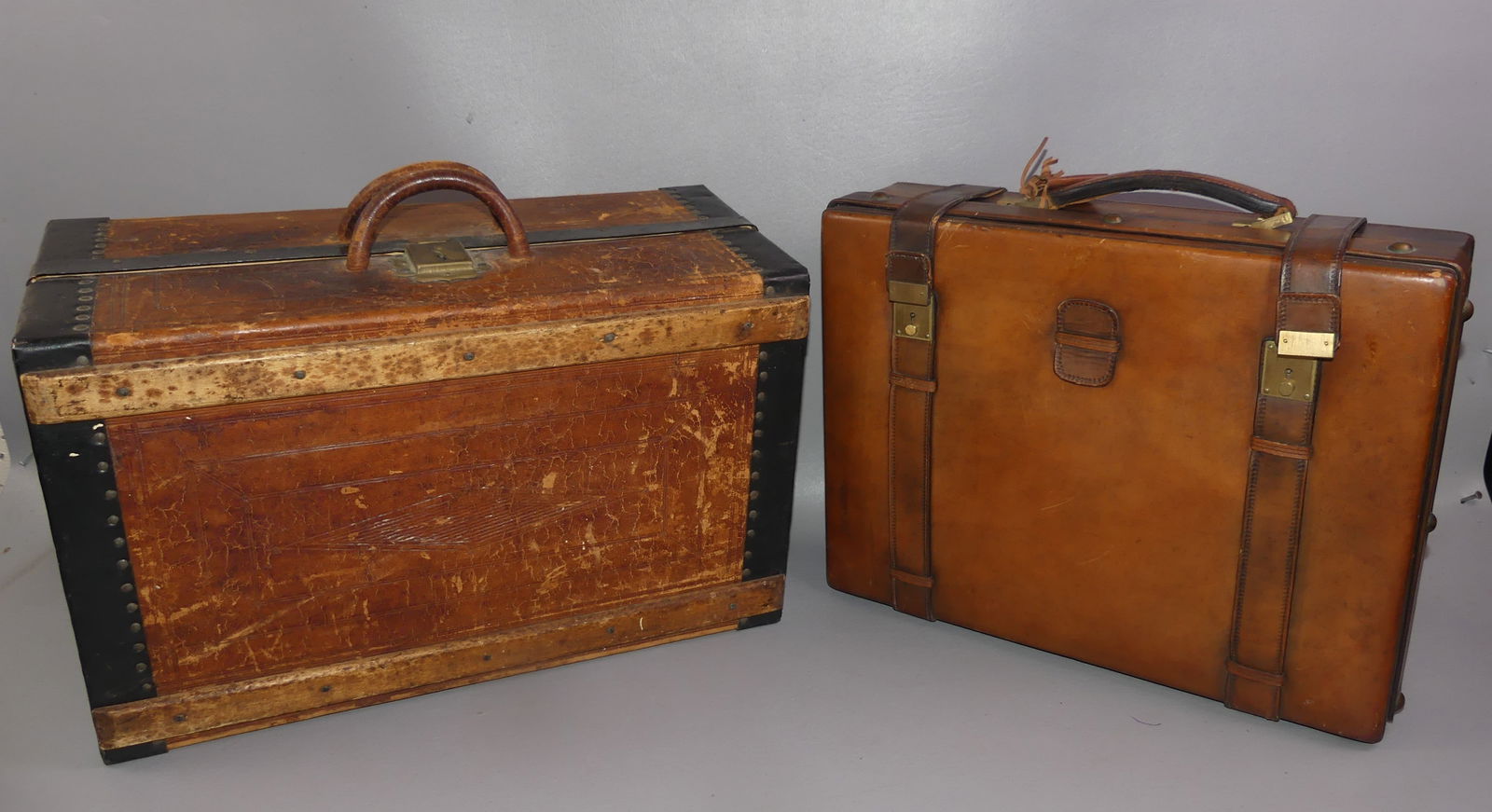 LEATHER BRIEFCASE & ANTIQUE SUITCASE: Lot of 2 items: fine quality leather briefcase initialed EK, 17 x 13 x 5 in; and leather, wood and metal suitcase stamped JS Taylor. Some wear, no key. 19 x 12 x 9 in. NOTE: We can ship this item in-h