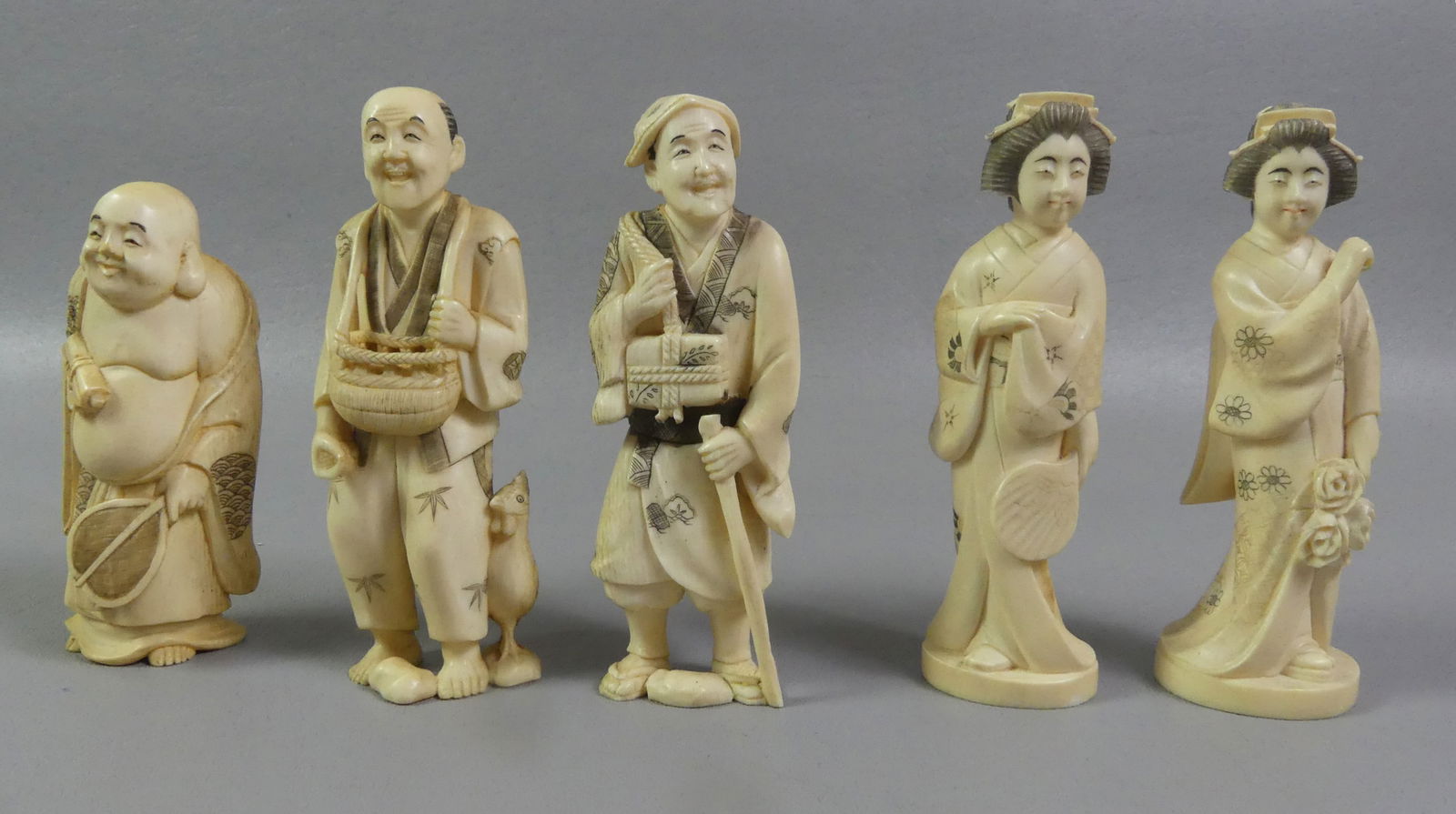 5 CARVED JAPANESE FIGURES: Lot of 5 Japanese carved bone figures to 5.25 in tall including pair of geishas and 3 men. Four are signed. NOTE: We can ship this item in-house.