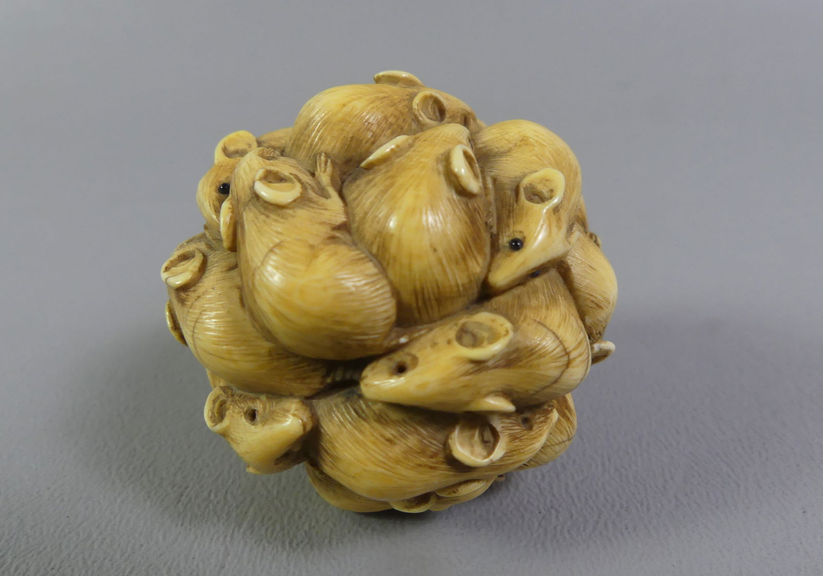 JAPANESE CARVED BALL - RATS: Antique Japanese carved ball with many rats having gemstone eyes. Unsigned. 1.75 inches diameter. Ex-collection of Andrew C. Ware.NOTE: We can ship this item in-house.