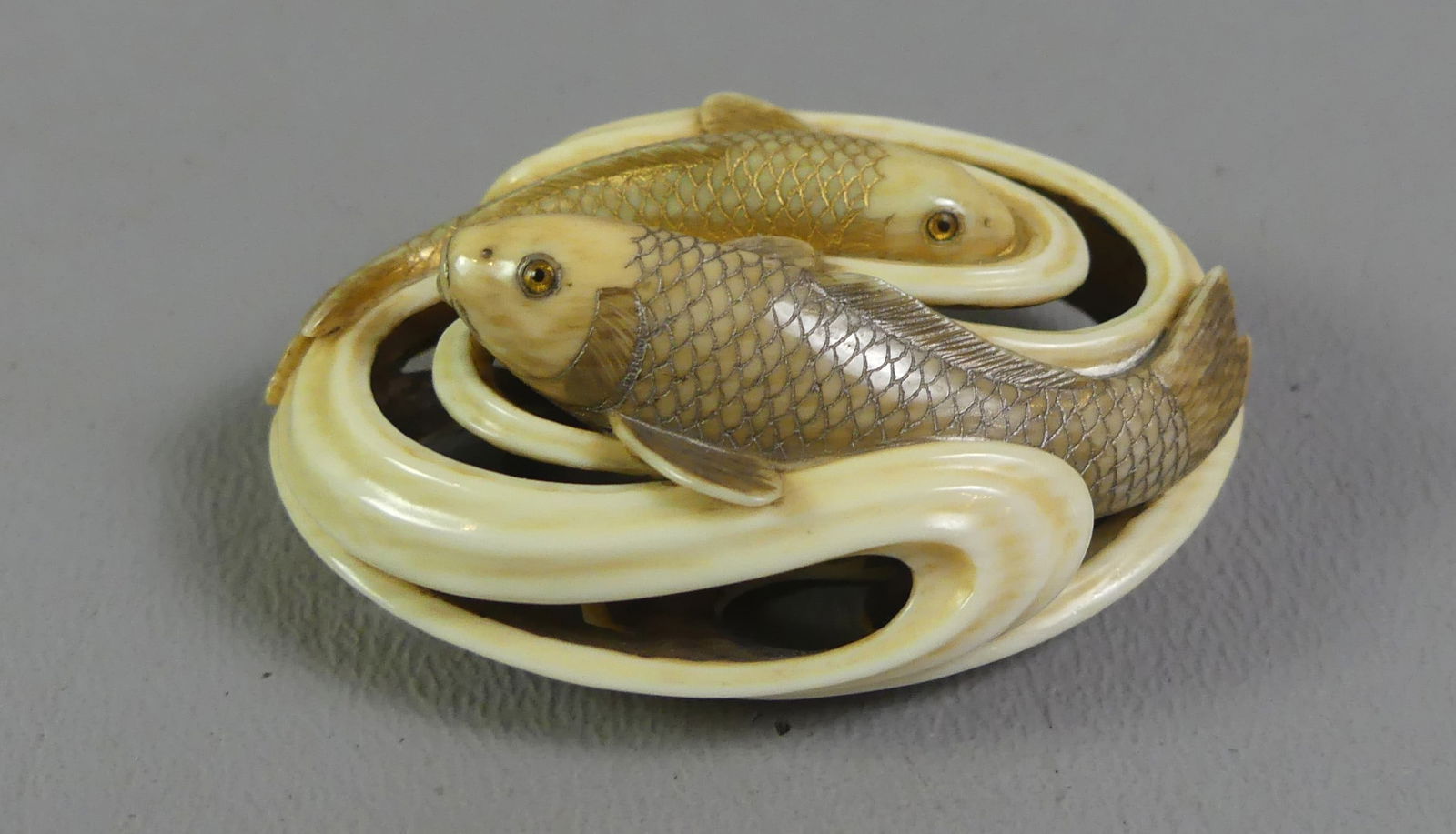 JAPANESE NETSUKE - KOI FISH: Wonderful antique Japanese ovoid, openwork polychromed netsuke with 2 swirling koi fish. Signed. 2 x 1.5 x .75 in high. Ex-collection of Andrew C. Ware. NOTE: We can ship this item in-house.