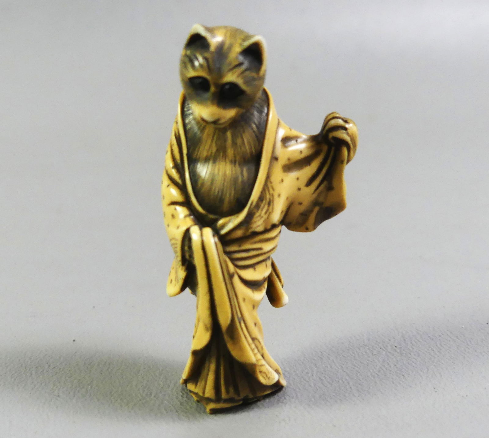 JAPANESE NETSUKE - STANDING CAT: Antique Japanese carved netsuke of a cat standing in robe, signed. 2.25 in tall. Ex-collection of Andrew C. Ware. NOTE: We can ship this item in-house.