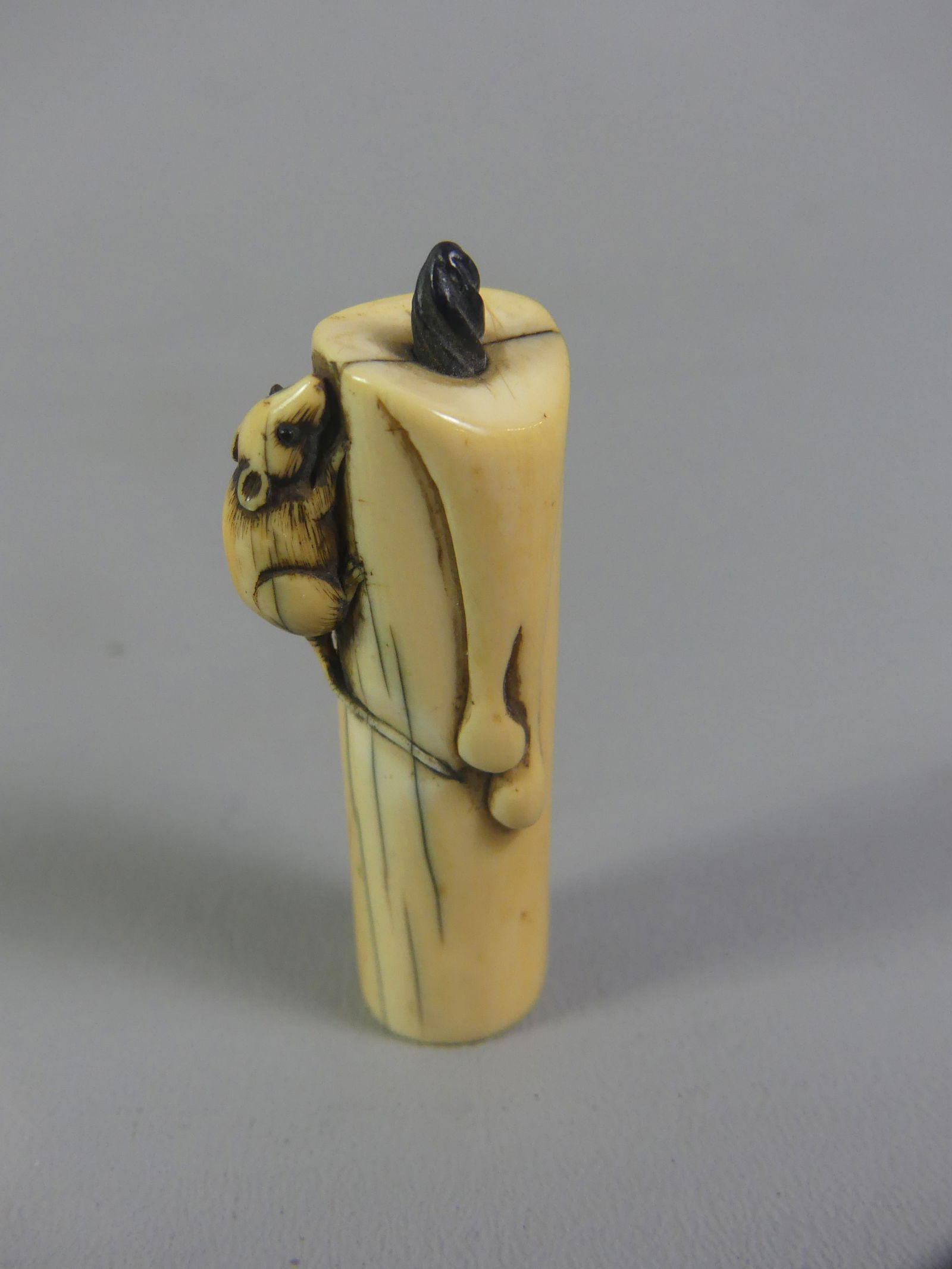JAPANESE NETSUKE - MOUSE ON CANDLE: Antique Japanese netsuke of a mouse climbing on a candle, unsigned. 2.25 tall x .75 inches. Ex-collection of Andrew C. Ware. NOTE: We can ship this item in-house.