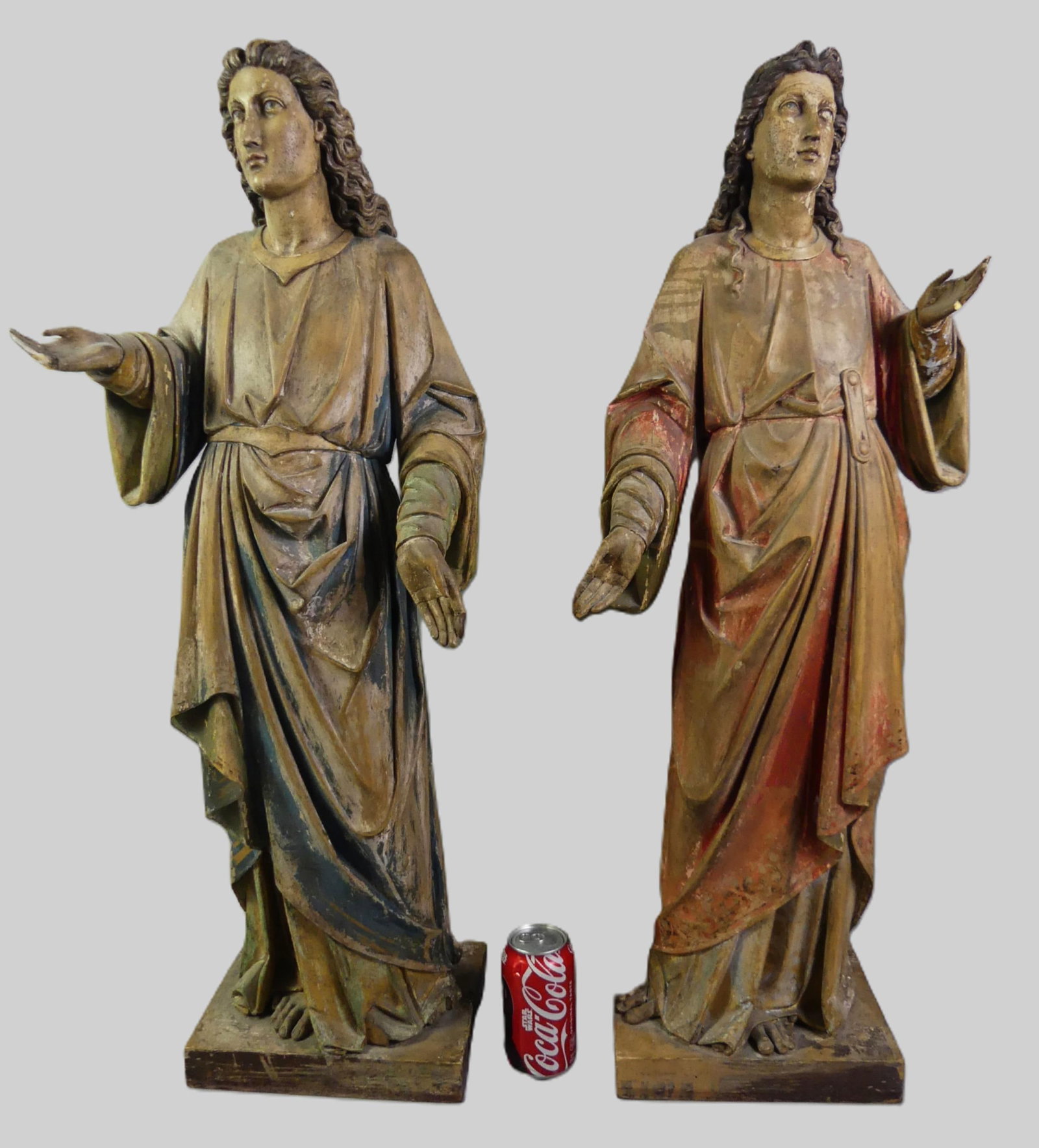 PR. 3 FT CARVED SAINT STATUES: Large pair of 19th century carved and polychromed religious statues of saints, each with hand raised. 35 in tall x 10 x 7 inches. Minor damage to each raised handle, wear to paint. Note: We can ship t