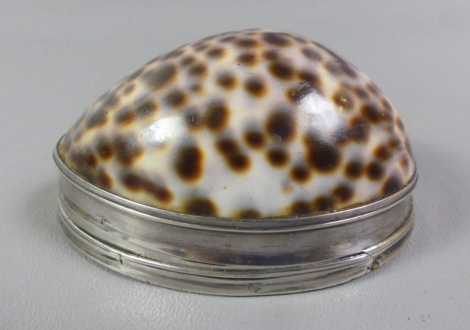 AMERICAN SILVER MOUNTED SHELL BOX: Antique sterling silver mounted seashell snuff or trinket box with engraved designs and cojointed initials on lid. Has impressed RM hallmark -possibly Robert Monteith (1814-1849). 3.25 x 2.5 x 1.5 in