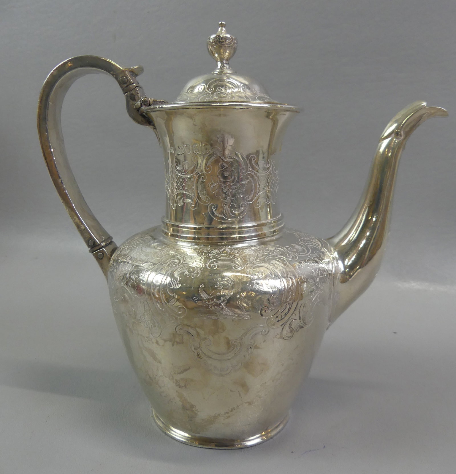 1865 LONDON STERLING SILVER TEAPOT: 19th century English sterling silver teapot with fancy engraved designs, hallmarks for London 1865, maker IET. Size: 8 in tall. Weighs 18.8 ozt.