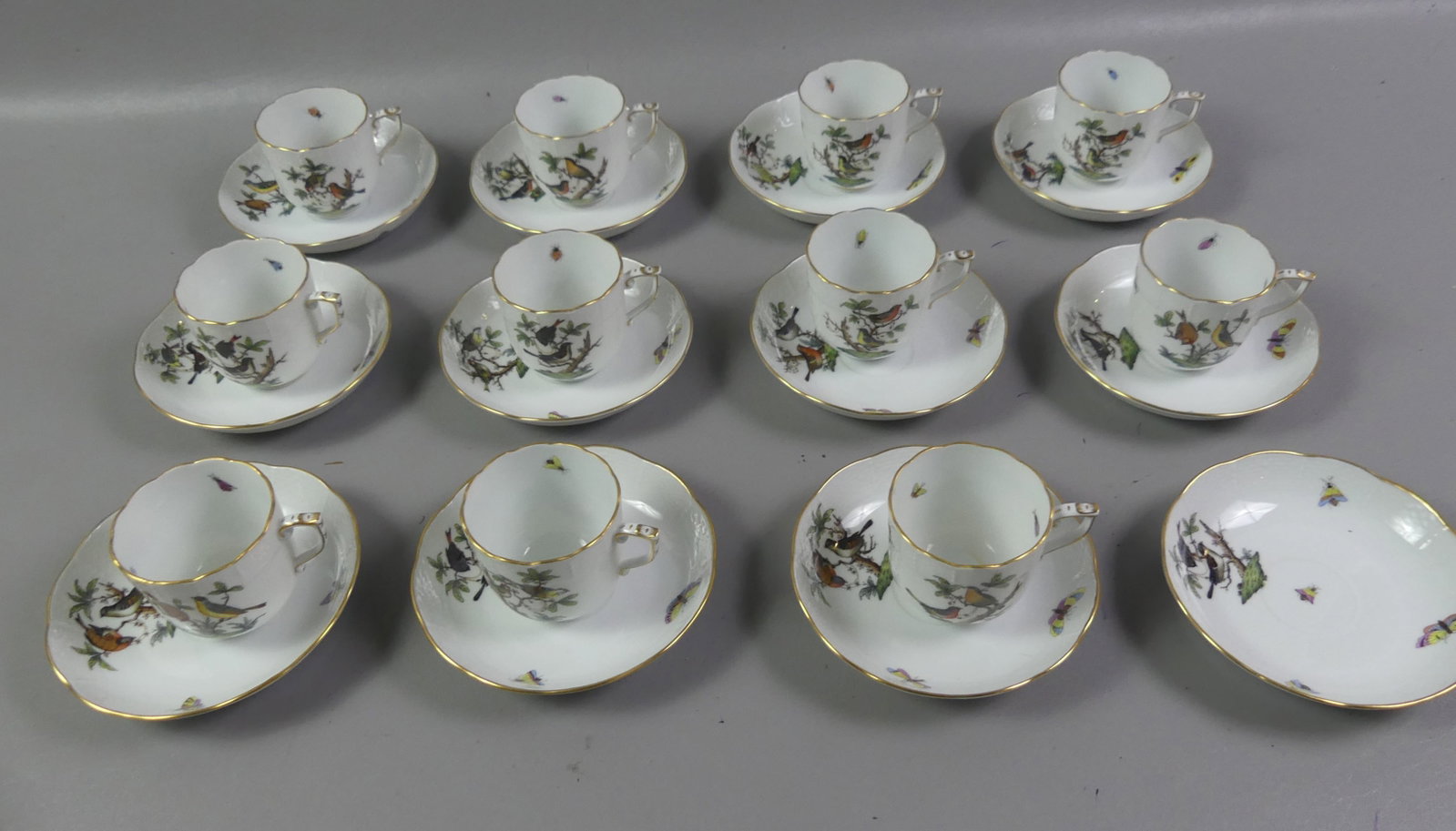 SET 11 HEREND CUPS & SAUCERS - ROTHSCHILD BIRD: Set of 11 vintage Herend hand painted cups and matching saucers (plus one extra saucer) in the Rothschild Bird design having colorful birds and insects. They have a basketweave design, #707. Size: