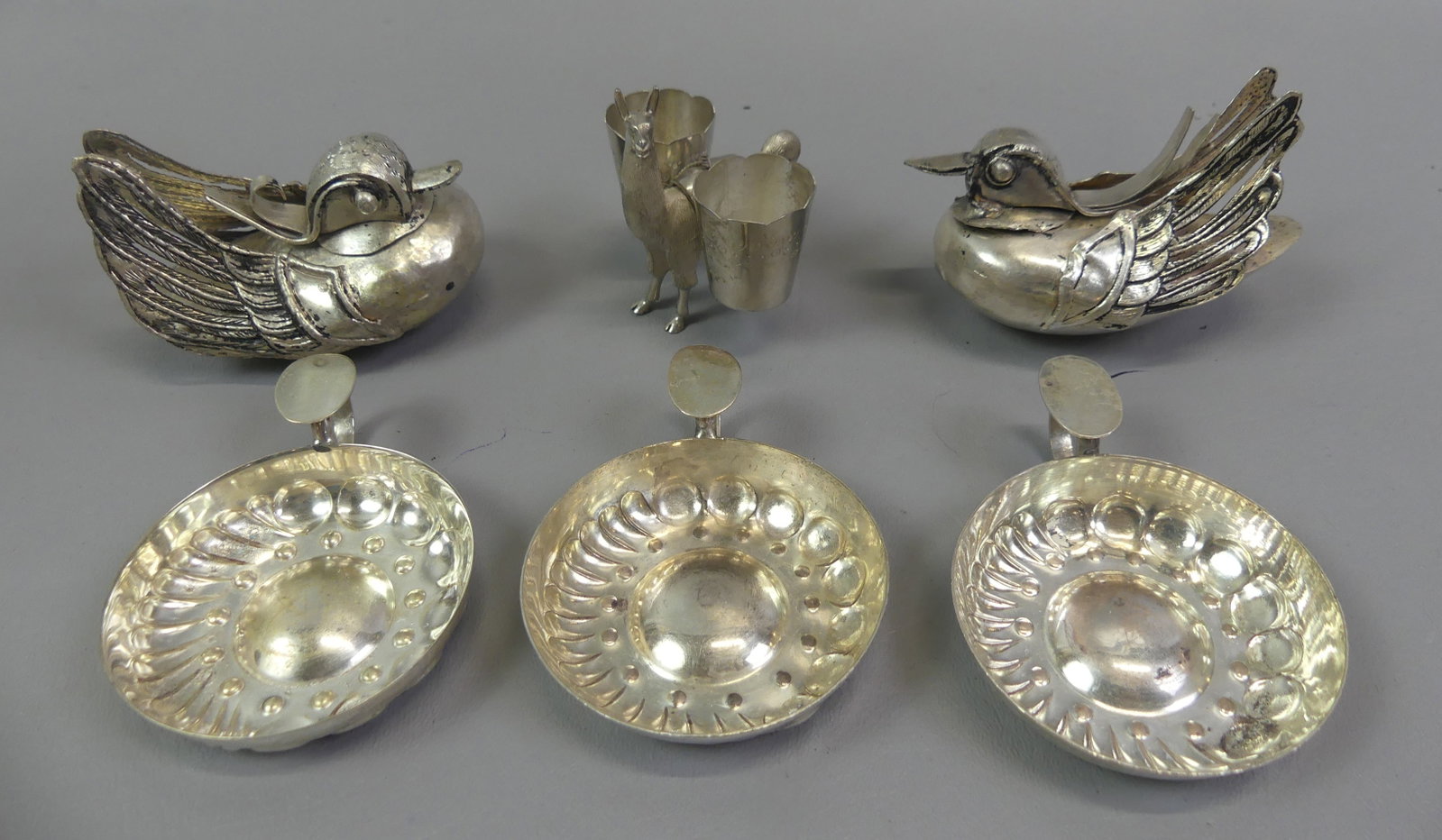 LOT OF SILVER INCL. 2 DUCK BOXES: Lot of old silver items: Pair of unusual duck-form containers with removable heads, 3.5 in long; sterling toothpick holder in form of a Llama, 3 in; and 3 wine tasting cups, unmarked. Total 12.15 ozt.