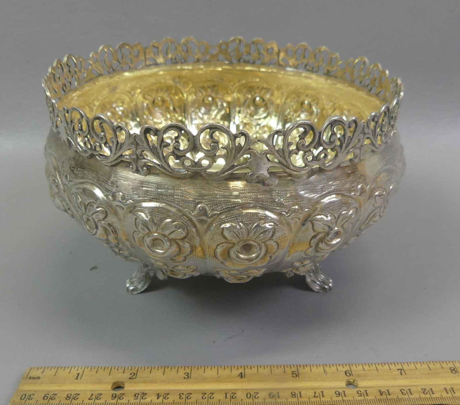 800 SILVER FOOTED REPOUSSE BOWL: Antique Continental .800 silver fancy footed bowl with reticulated rim, repousse flowers and gilt interior. Has hallmarks possibly German. 7.5 in x 5 in deep. Weighs 14.5 ozt.