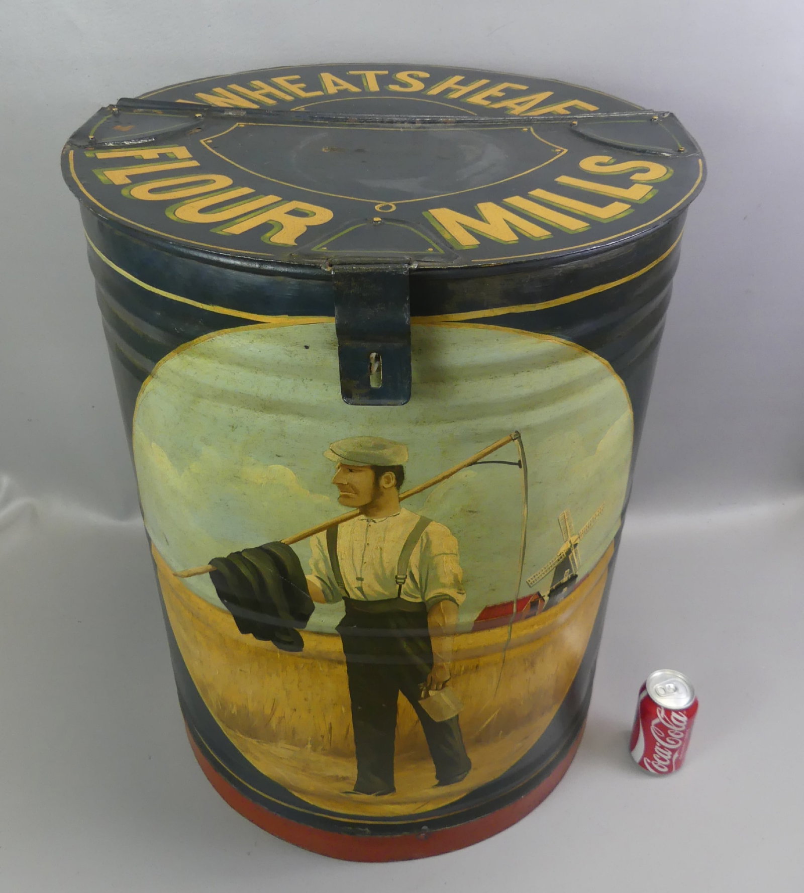 WHEATSHEAF FLOUR MILLS BARREL - FARMER: Large, rare, old hand painted metal flour storage barrel WHEATSHEAF FLOUR MILLS with scene of a farmer in field with windmill. Has hinged lid, 27.5 in tall and 21 in wide. Good condition. NOTE: The