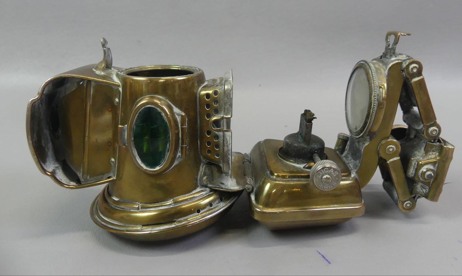 ENGLISH BICYCLE LAMP - SILVER KING: Antique brass bicycle fluid lamp with label for Joseph Lucas SILVER KING, Birmingham England. Has 2.5 in colorless lens with green and red glass side jewels and interior kerosene burner. Flexible