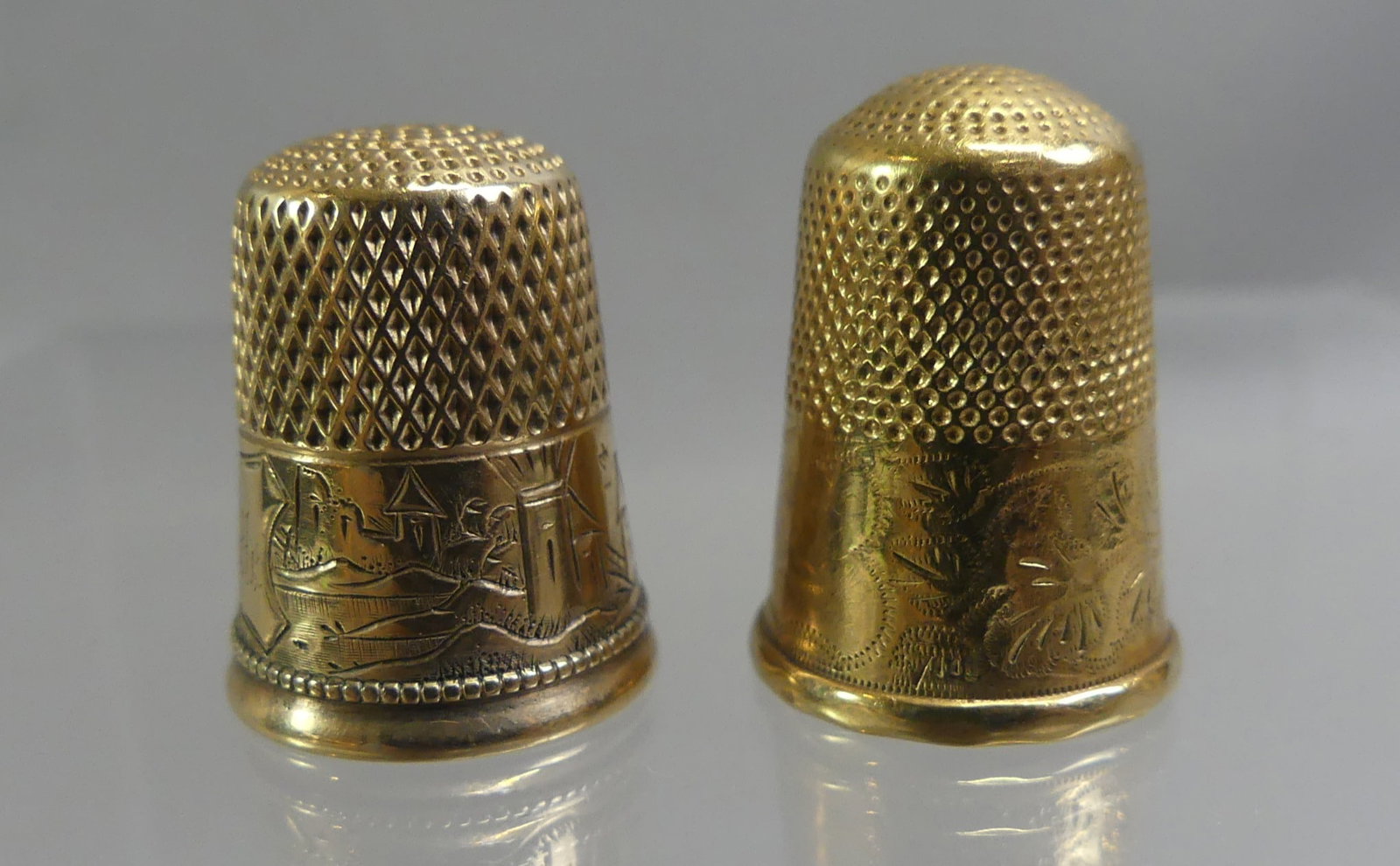 TWO 14K GOLD THIMBLES: Lot two 14k gold thimbles with engraved designs. 3/4 inch high, weighs total of 5.65 dwt.