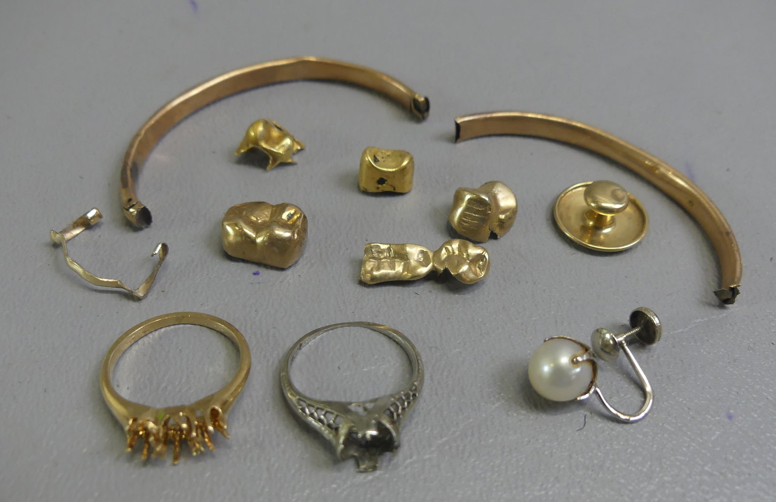 SCRAP GOLD LOT 10K-14K: Lot of scrap gold: 2 rings missing stones; and 5 gold tooth fillings, etc. Total 10.45 dwt.