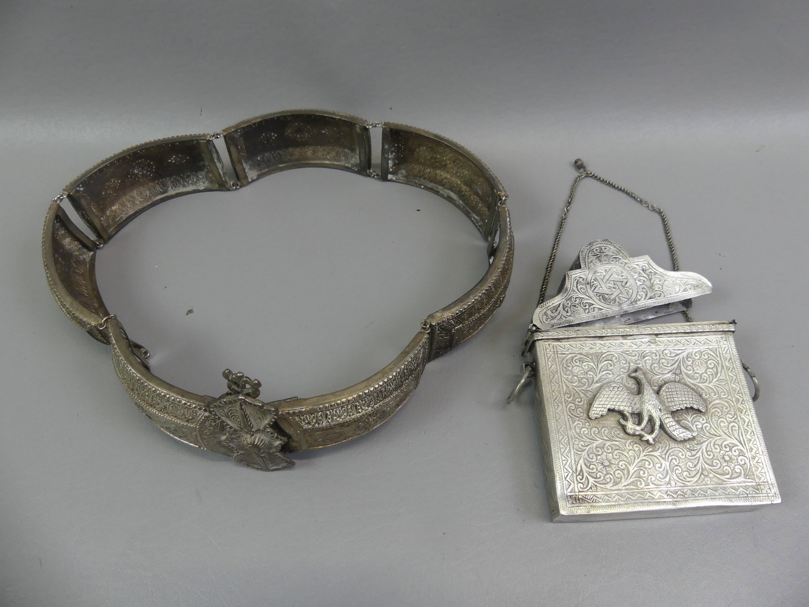 MIDEAST SILVER BELT & EAGLE PURSE: 2 Middle Eastern items: 30 in long silver plated belt with elaborate designs (2 in wide); and lift-top silver card case purse with Eastern Star and embossed eagle (hinge damaged), 6 x 4.5 in. Purse