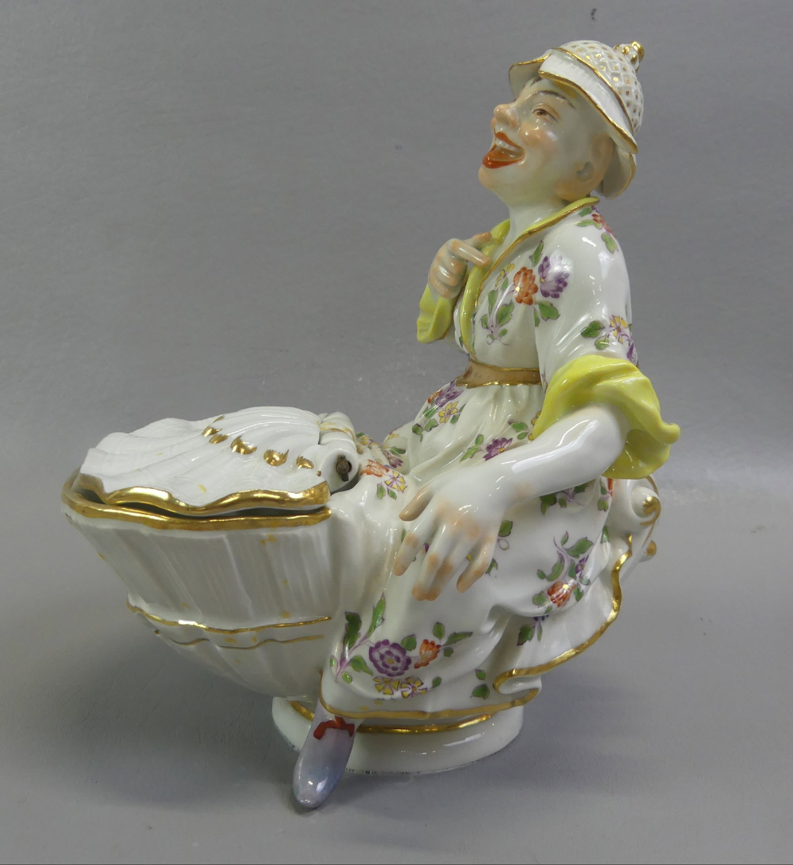 MEISSEN FIGURAL SWEETMEAT DISH - CHINOISERIE: 18th century Meissen porcelain figural sweetmeat dish with laughing figure of a Chinese man. Has crossed swords underglaze mark and #125 and 750. Size: 8 in tall, 5 in wide. Has small chip on lid