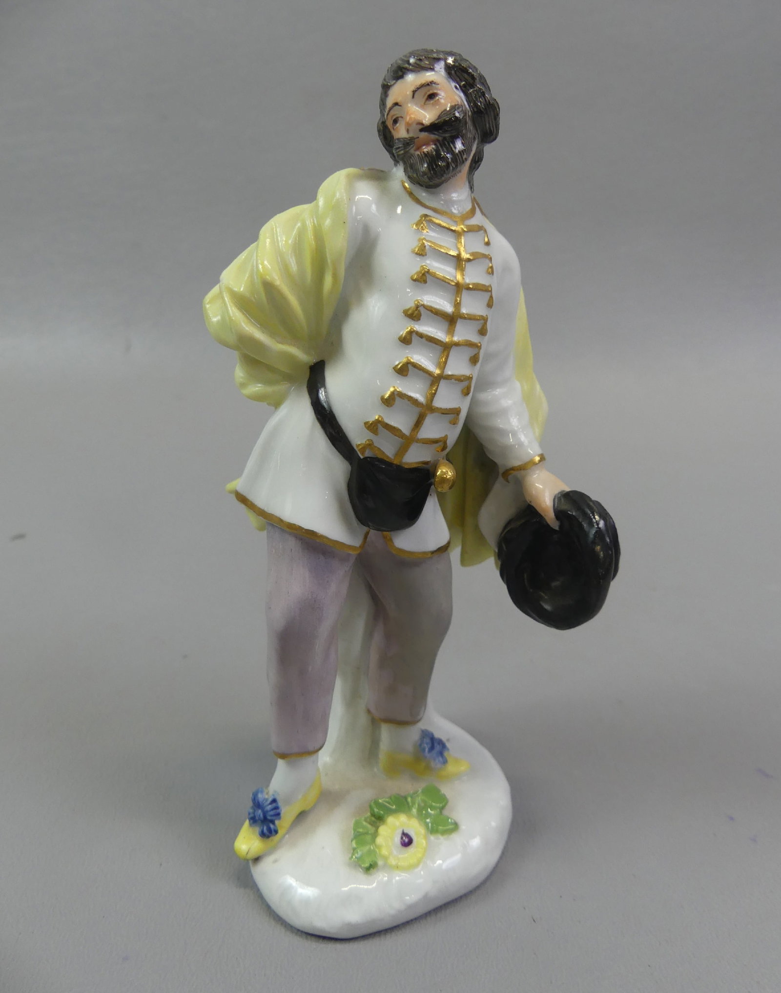 MEISSEN FIGURINE OF MAN - SCAPIN: 18th century Meissen figurine depicting the character Scapin, the Duke of Weissenfels (from the Italian Commedia Dell'Arte series) , modeled in 1744 by P. Reinicke. 5.25 in tall. Has blue underglaze