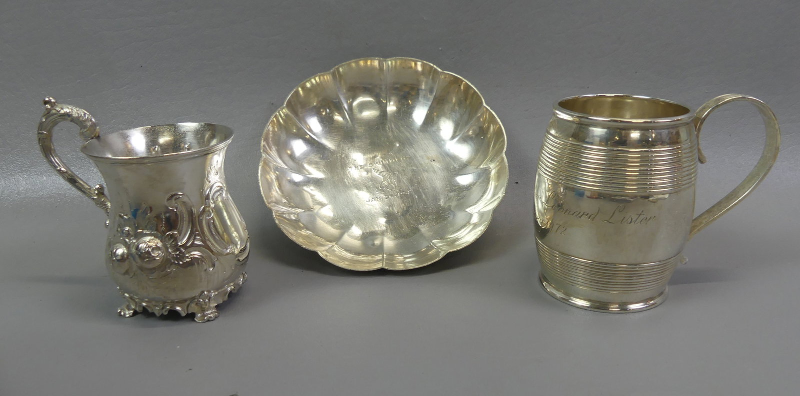 TIFFANY STERLING CUP & BOWL & ENGLISH CUP: Lot of sterling silver: Tiffany & Co. barrel-form mug dated 1972 with engraved name, 3.5 in; Tiffany 5 in bowl with 1947 engraving THE SWIMMERS; AND Mappin Bros. English repousse cup dated 1860.
