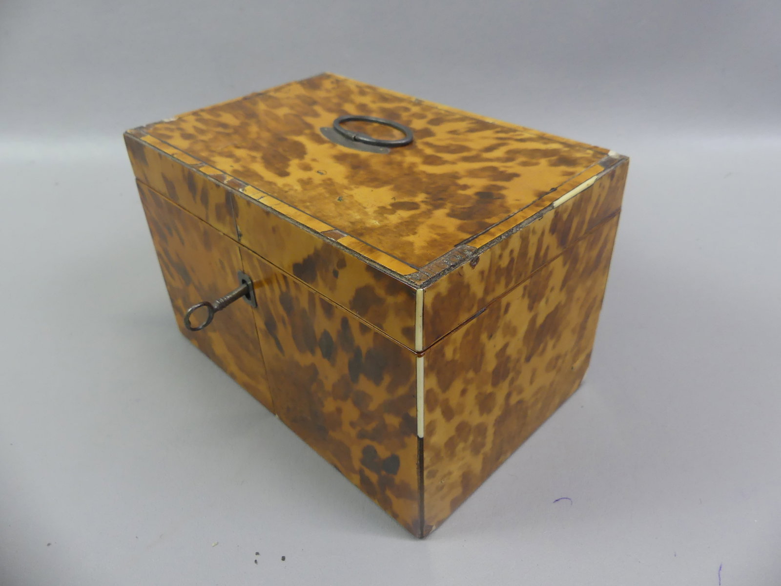 REGENCY SHELL VENEER DOUBLE TEA CADDY: Circa 1800 Regency period shell veneer double tea caddy box with key. Has English sterling handle with hallmark of JS maker. One interior lid missing, losse hinge, minor loss to veneer. 8 x 5 x 5