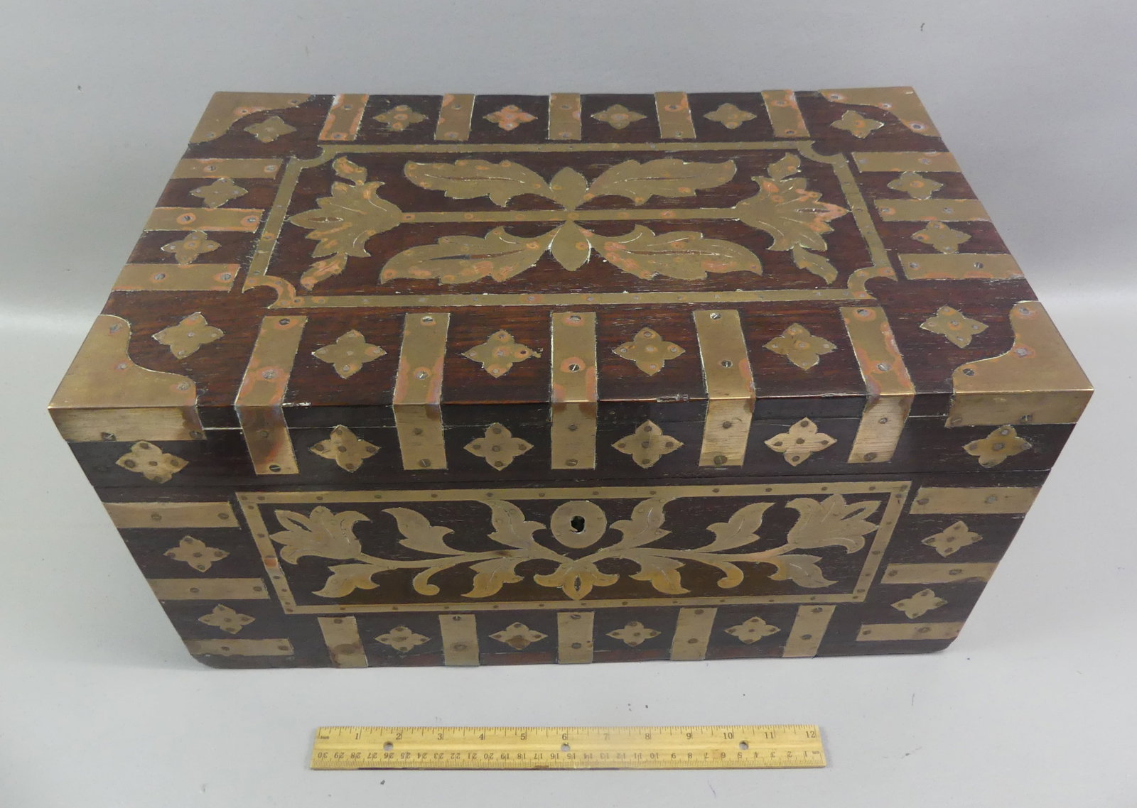ANGLO-INDIAN ROSEWOOD CAMPAIGN BOX: Mid 19th century solid rosewood Anglo-Indian officer's campaign box / traveling desk having multiple fitted compartments and letter holder. Exterior has elaborate brass inlay. With key. 19 x 12 x 10 i