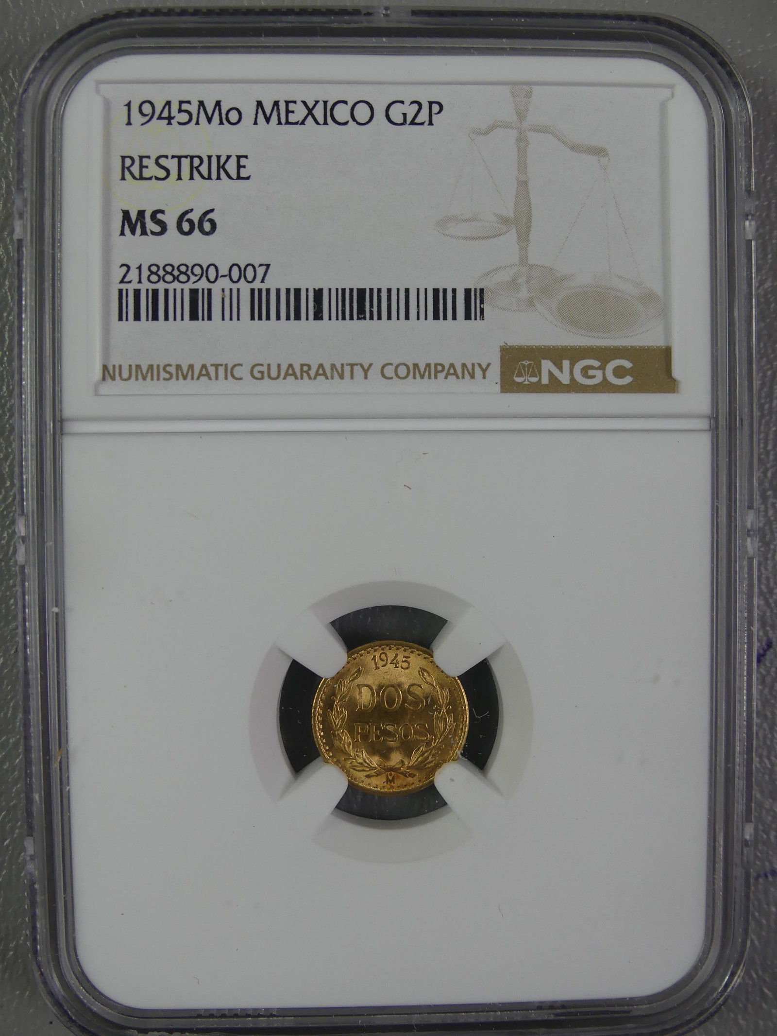 1945 MEXICAN 2 PESOS GOLD COIN: NGC slabbed and graded 1945-MO Mexican 2 peso gold coin (restrike) - graded MS-66. 12.7mm. 1.66 grams and .90 gold content