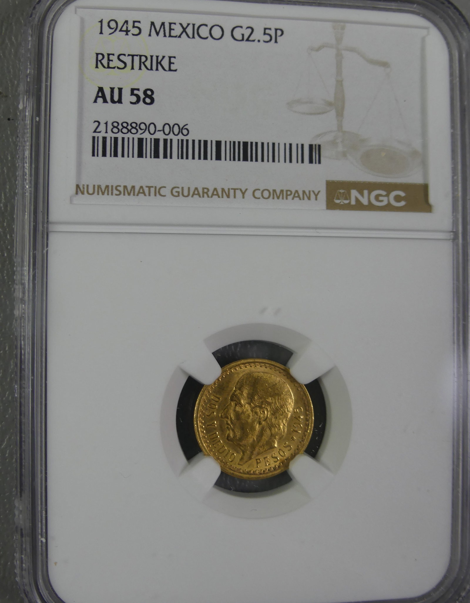 1945 MEXICAN 2.5 PESOS GOLD COIN: NGC slabbed and graded 1945 Mexican 2.5 pesos gold coin (restrike) graded AU-58. 15.74mm.