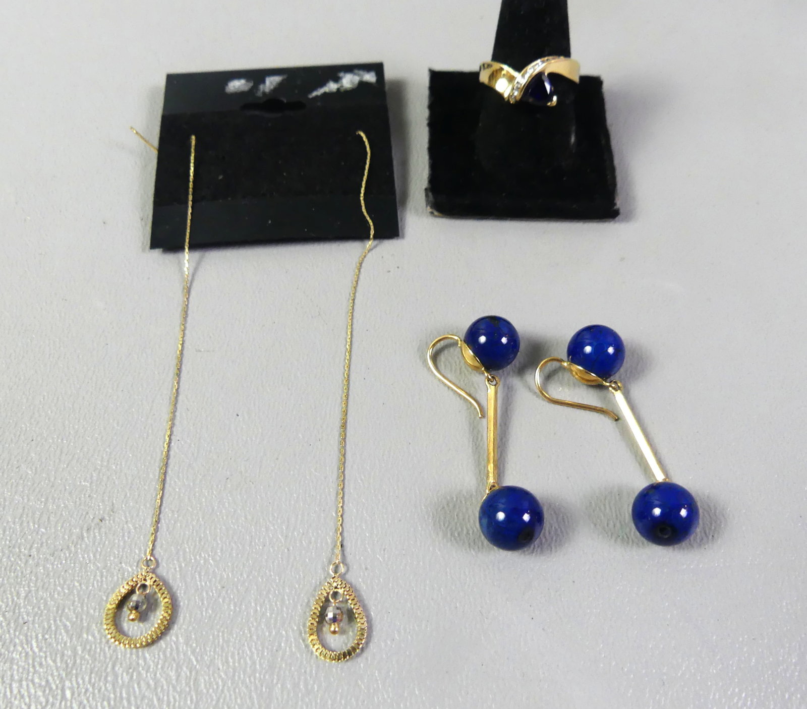 14K GOLD RING & EARRINGS: Lot of 14k gold jewelry: Size 7.5 sapphire and diamond ring; pair of needle and thread long earrings; pair of lapis ball earrings, 1.5 in long. Total 8.25 dwt.