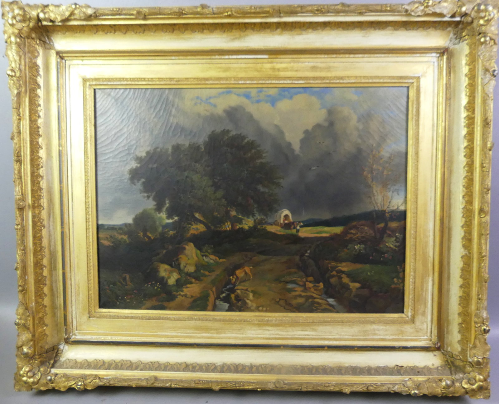 19TH C. LANDSCAPE PAINTING WITH CONESTOGA WAGON: Circa 1860 oil landscape painting on canvas depicting a conestoga wagon and figures in distance with dog drinking from stream in foregroound. Unsigned. 17 x 23 in, framed 27 x 33 in. Good condition.