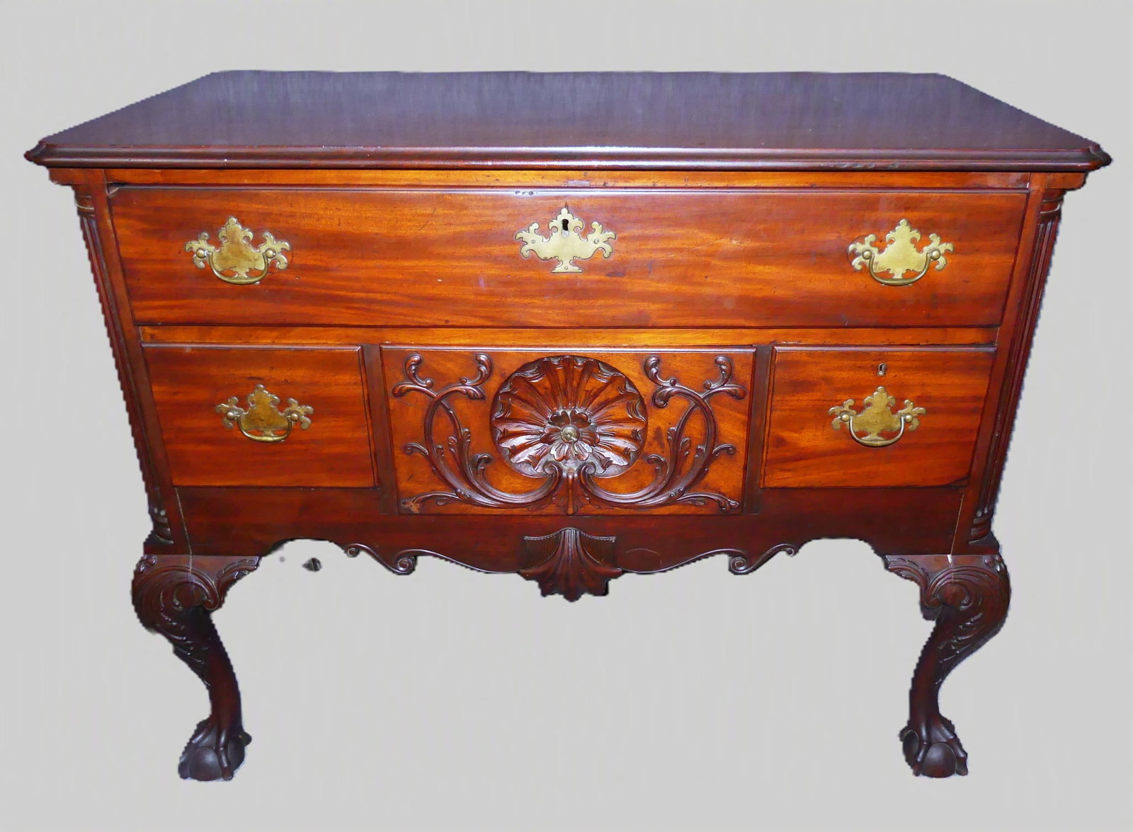 PERIOD PHILADELPHIA CHIPPENDALE LOWBOY: Fine circa 1760 Pennsylvania Chippendale mahogany lowboy with ball and claw feet, carved knees, fluted 1/4 columns, and shell-carved center drawer. One piece top with shaped corners. Good overall