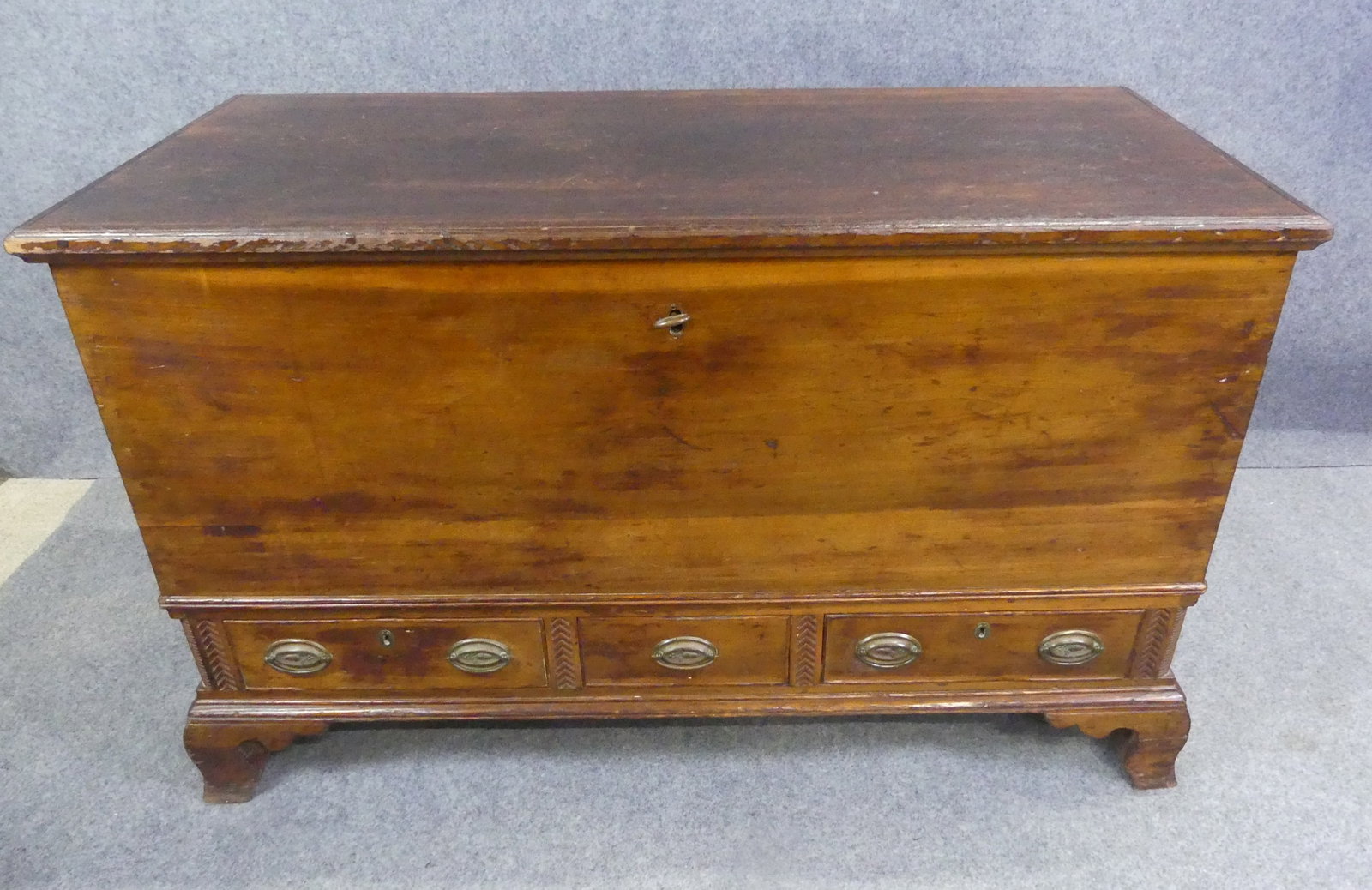 PERIOD PENN. BLANKET CHEST: 18th century Pennsylvania poplar 3 drawer blanket chest with carved lower skirt and bracket feet. Has interior till with 3 small drawers, comes with key. 50 in long x 23 x 30 in high.