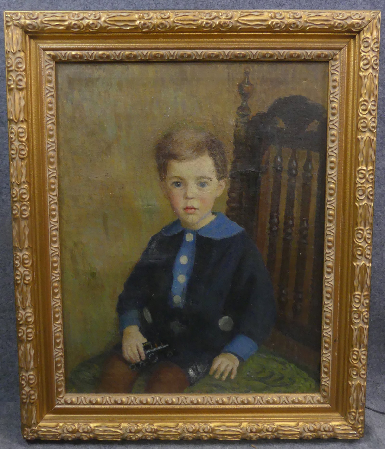 MARGARET TYNG PORTRAIT - BOY WITH TRAIN: Oil portrait of young boy seated in chair holding a toy train. Signed in upper left Margaret Fuller Tyng. 28 x 22 in, framed 35 x 29 in. Has some scattered restoration. (Margaret Tyng 1878-1965 Boston