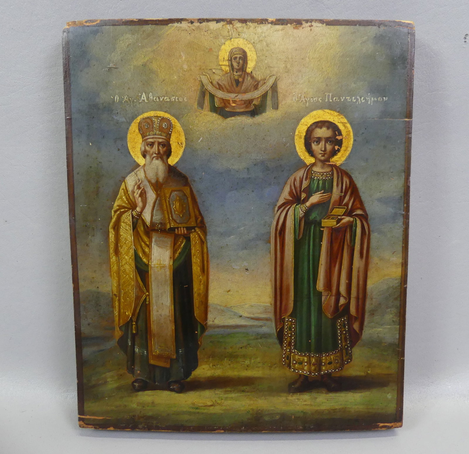 ANTIQUE GREEK ICON OF SAINTS: 19th century Greek painted icon of the Madonna and 2 saints (Saint Panteleimon & Saint Athanasius). 10.5 x 8.5 x one inch thick.