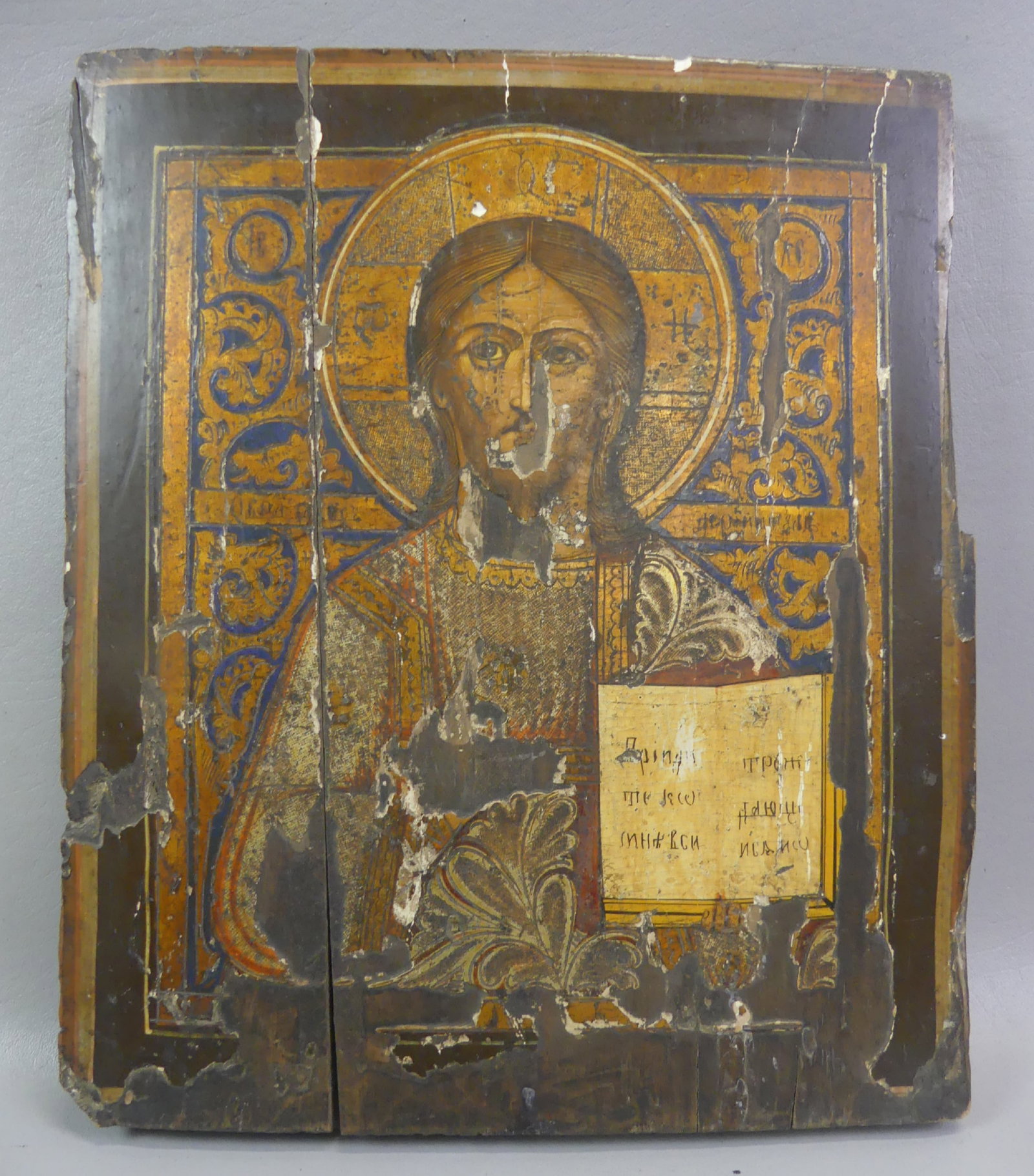 ANTIQUE RUSSIAN ICON - JESUS: Antique Russian painted wood icon of Jesus holding the gospel. As found condition. 14 x 12 inches.