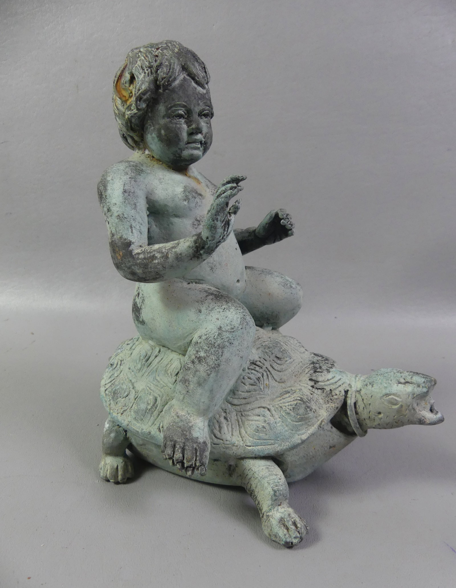 TABLE TOP FOUNTAIN - BOY ON TURTLE: Small vintage verdigris bronze table top fountain of a boy riding a turtle. Unsigned. Has hole in tail and mouth for water. 9 in tall and 8 in wide.