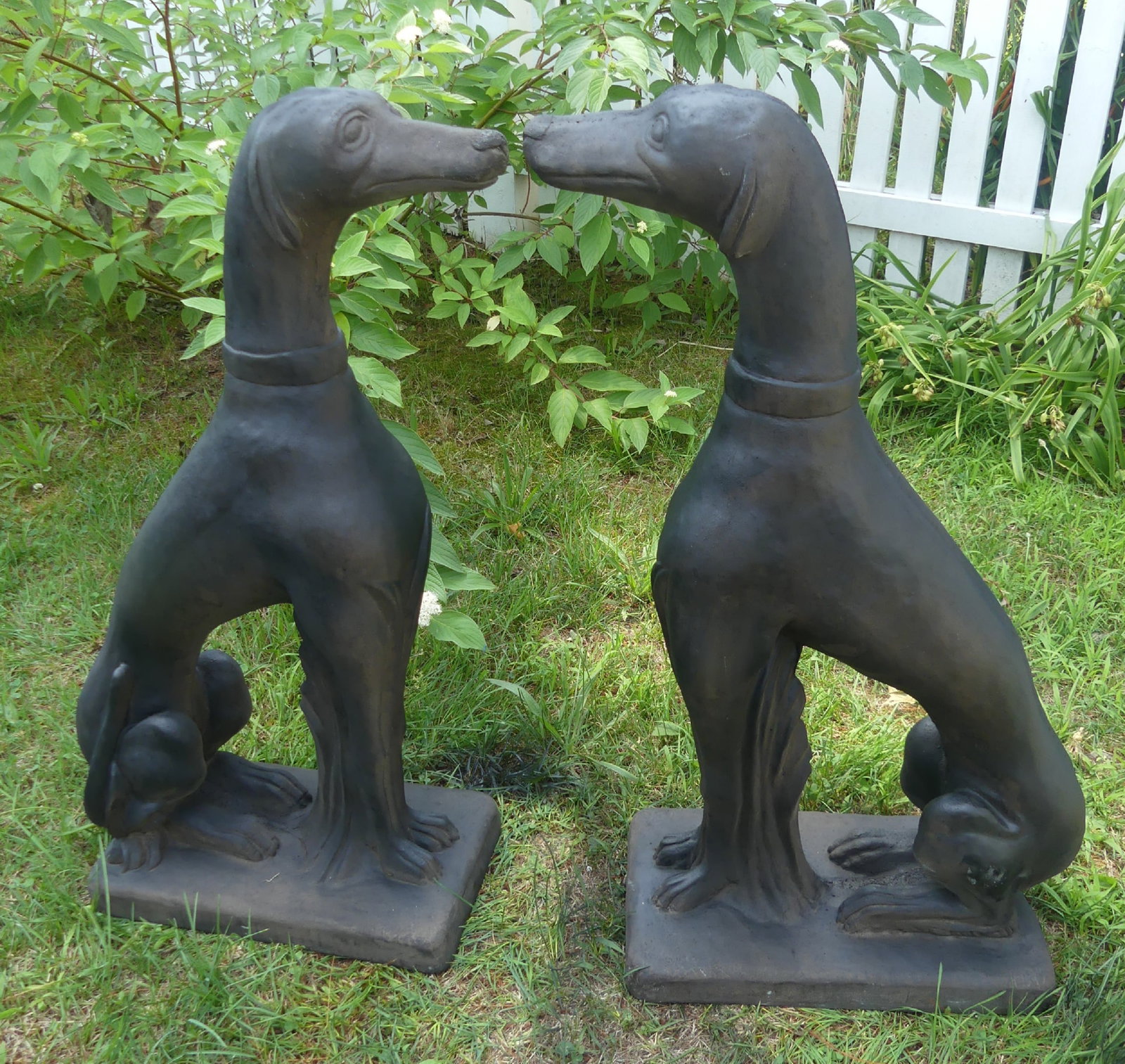 PAIR STONE GARDEN STATUES - WHIPPETS: Pair of vintage garden statues (stone or cement) in the form of whippet dogs. 30 x 16 x 8 inches. Good condition, has some paint touch-up.