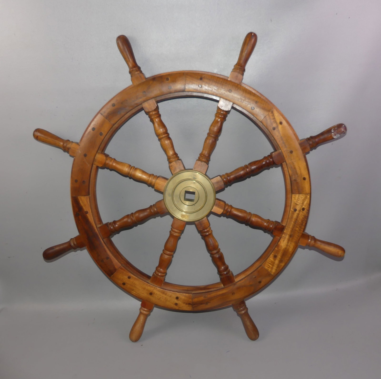 3 FT. SHIP'S WHEEL: Old teak or walnut ship's wheel with brass hub. 37 in diameter.