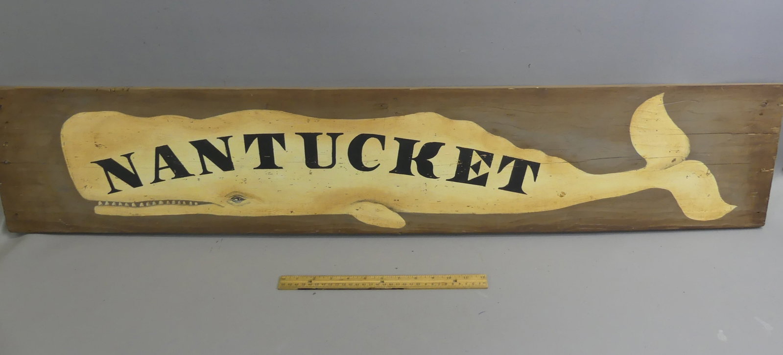 PAINTED WOOD NANTUCKET WHALE SIGN: Vintage painted wood wall plaque NANTUCKET with whale. 4 ft long by 9 in high.