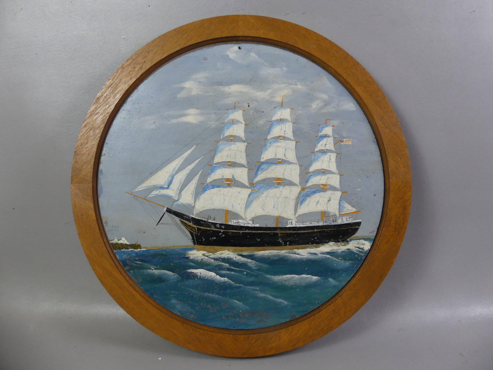 JOHN IVORY SHIP PAINTING: Circular oil painting on board of an American clipper ship A.J. Fuller by itinerant Nantucket artist folk artist John Ivory (unsigned). 19 in diam, 22.5 in framed. Has scattered chipping to paint.