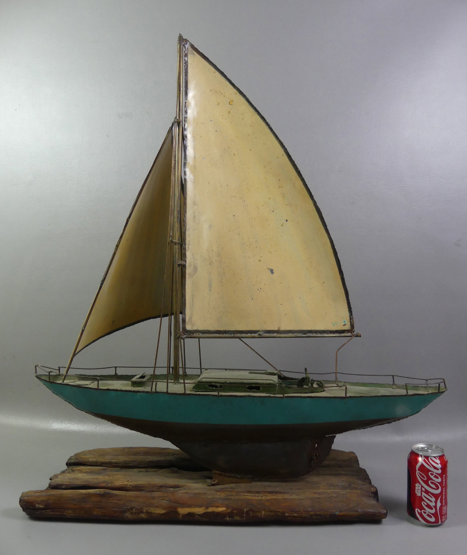 OLD SHEET METAL YACHT MODEL: Old sheet metal yacht model on wood base signed Houk (?). 33 x 29 x 9 inches.
