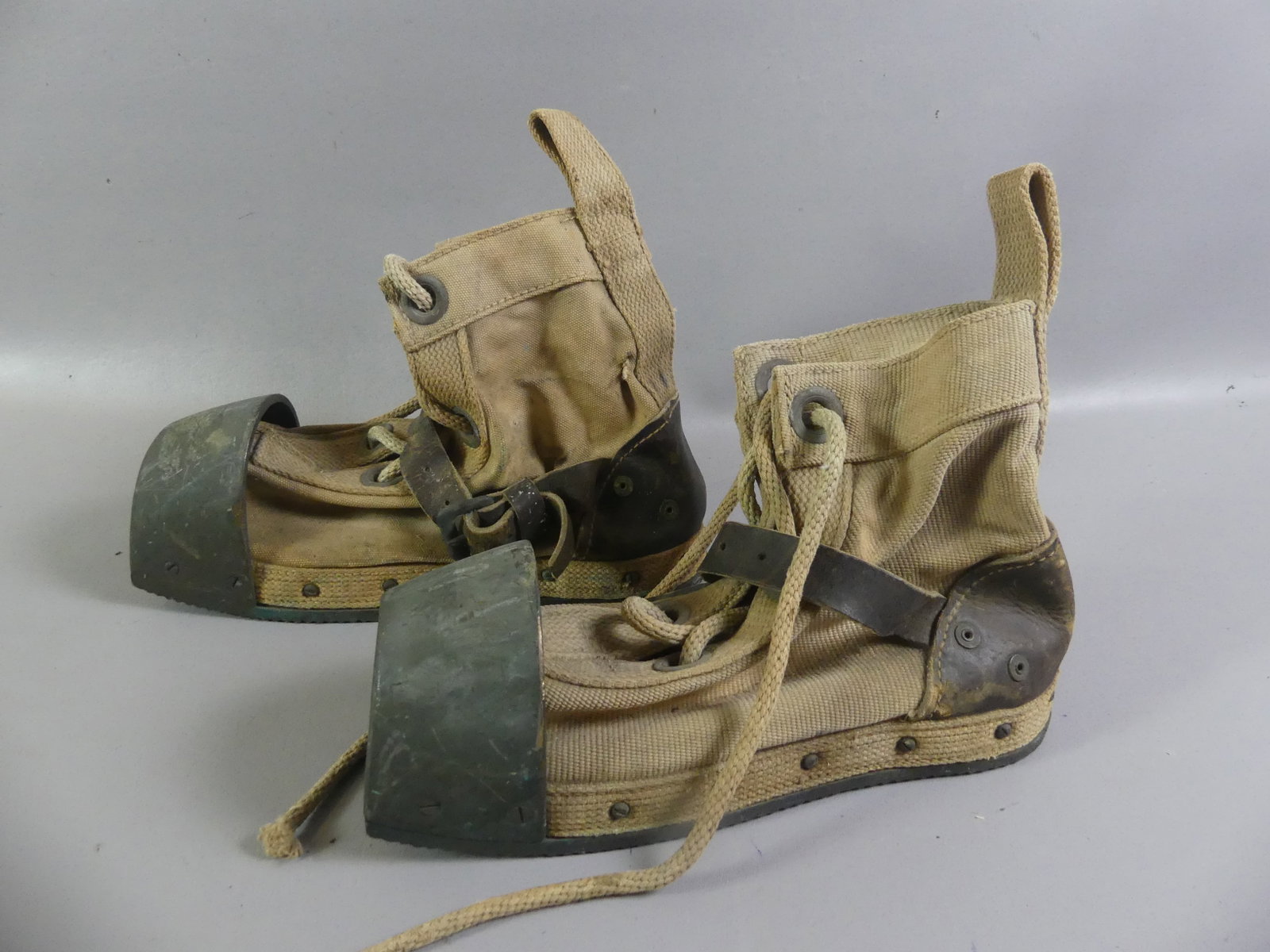 PAIR ANTIQUE DIVERS BOOTS: Pair of heavy, old diver's boots made from bronze, leather, and canvas with rope laces. 14 in long. Good condition.